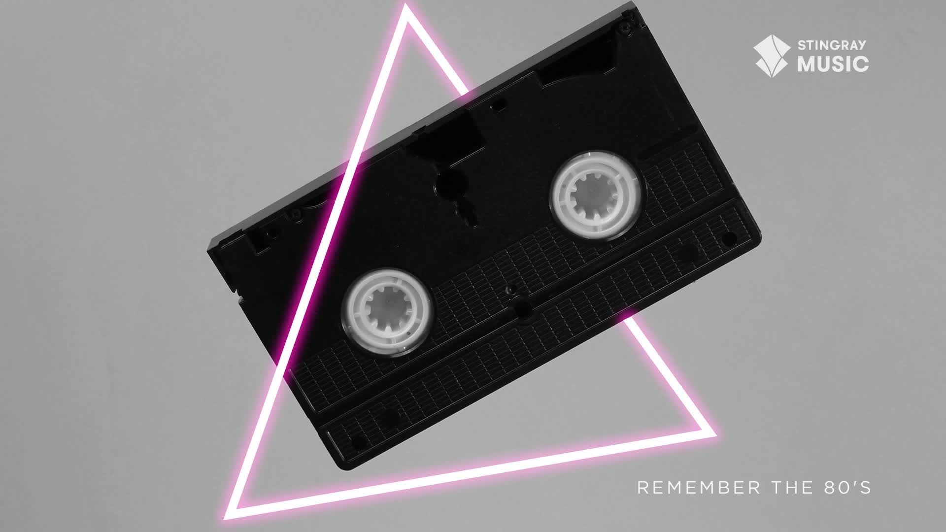 A black VHS tape hovers, framed by a glowing pink triangle. The Stingray Music logo and "Remember the 80's" text evoke a nostalgic mood.
