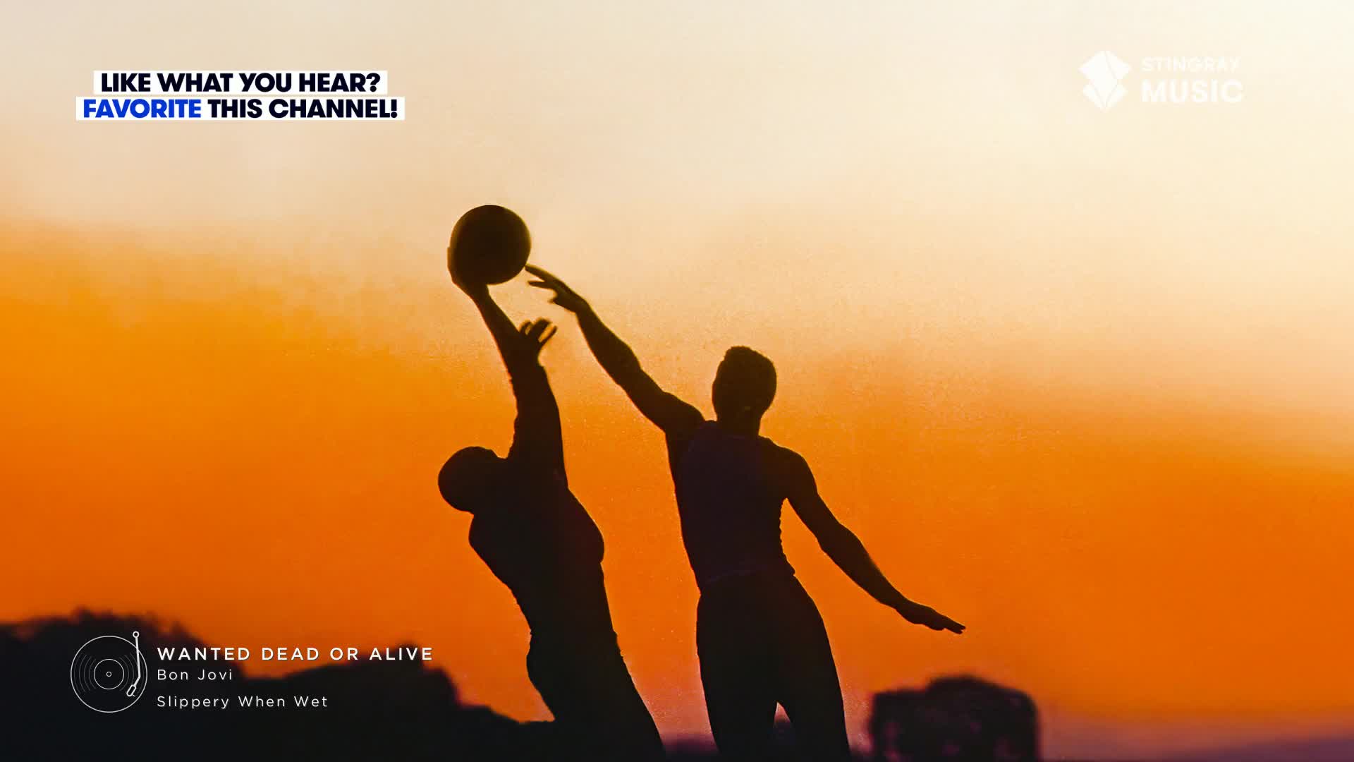 Two figures reach for a ball against a fiery sky, their silhouettes stark. The Stingray Music logo sits above the title "Wanted Dead or Alive" by Bon Jovi, a perfect soundtrack for this Canadian scene.
