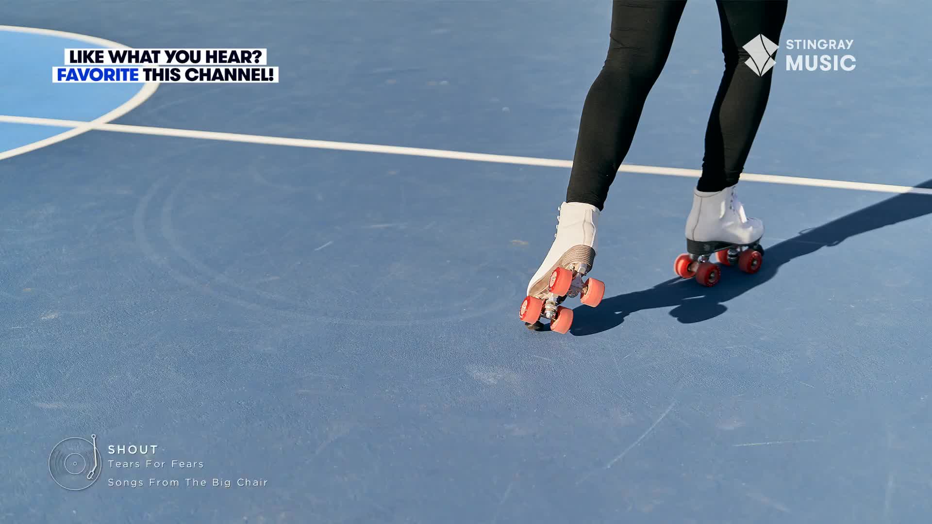 Someone glides across the blue surface, the red wheels of their skates rolling smoothly. The Stingray Music logo and the Tears for Fears song "Shout" suggest this is part of a retro music video from Canada.
