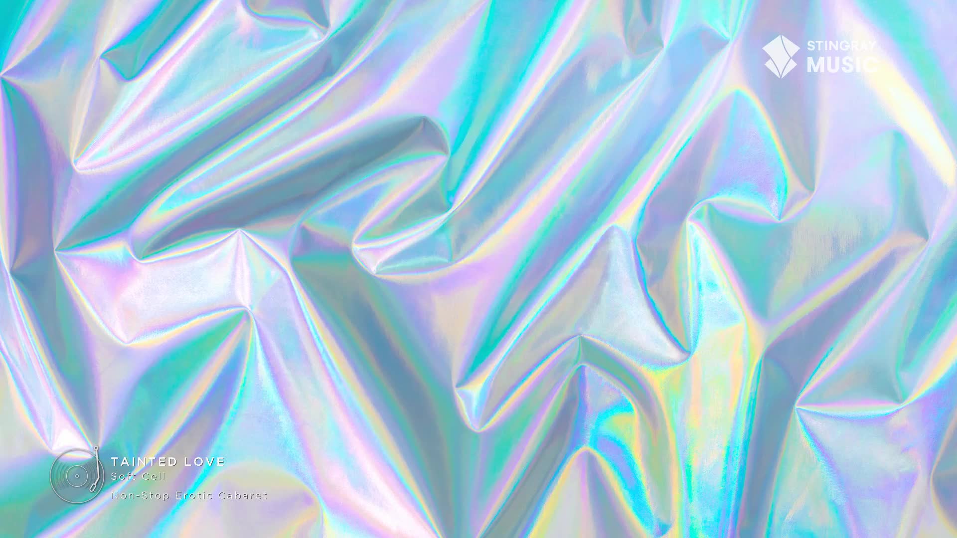 Iridescent fabric shimmers, its folds catching light in shades of turquoise and lavender. The Stingray Music logo sits in the corner, a reminder of the '80s vibe.
