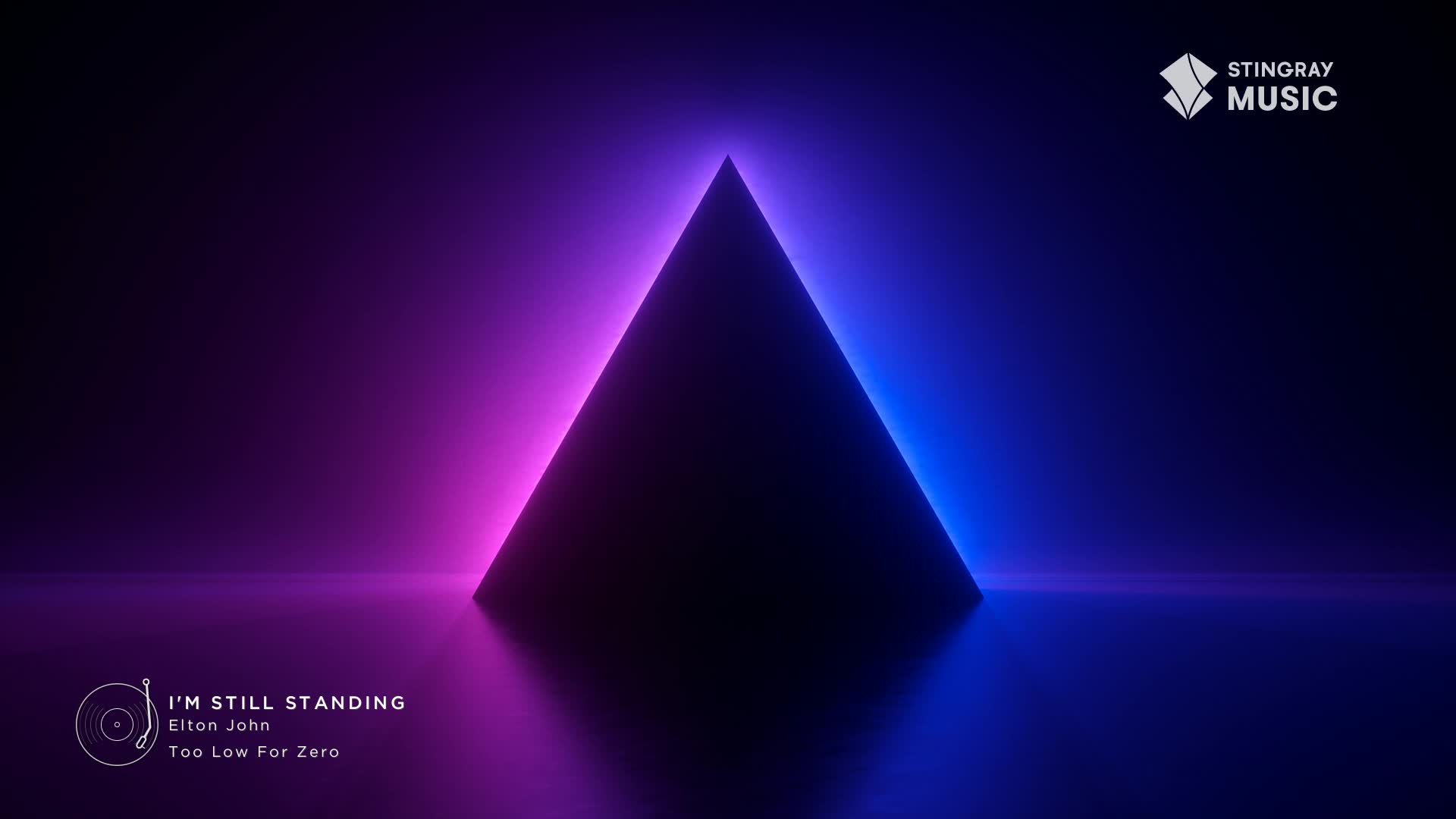 A dark, triangular shape is silhouetted against a gradient of pink and blue light. The Stingray Music logo sits in the upper right corner, and the Elton John song, "I'm Still Standing," is playing on the screen.
