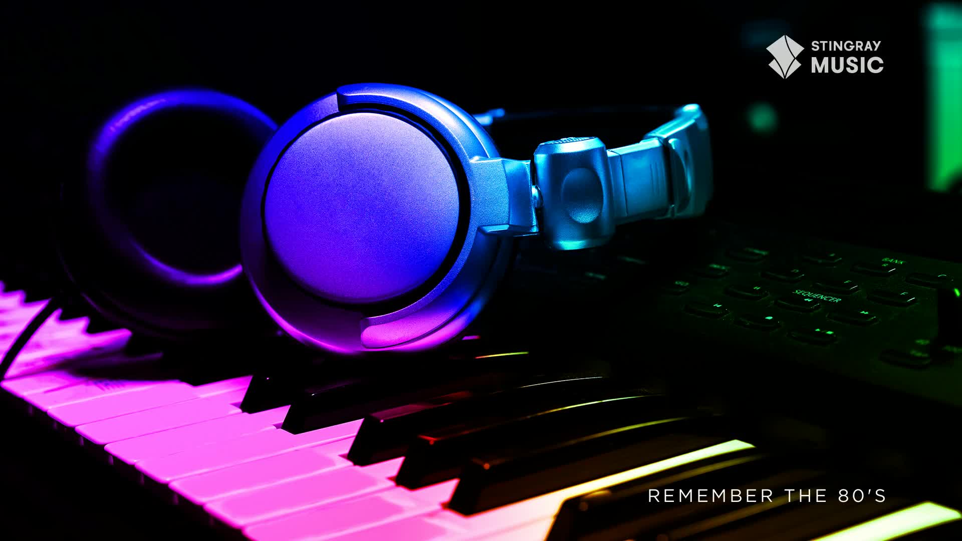 A pair of blue headphones rests on a keyboard, its keys bathed in purple and pink light. The Stingray Music logo is visible, promising a trip back to the '80s.
