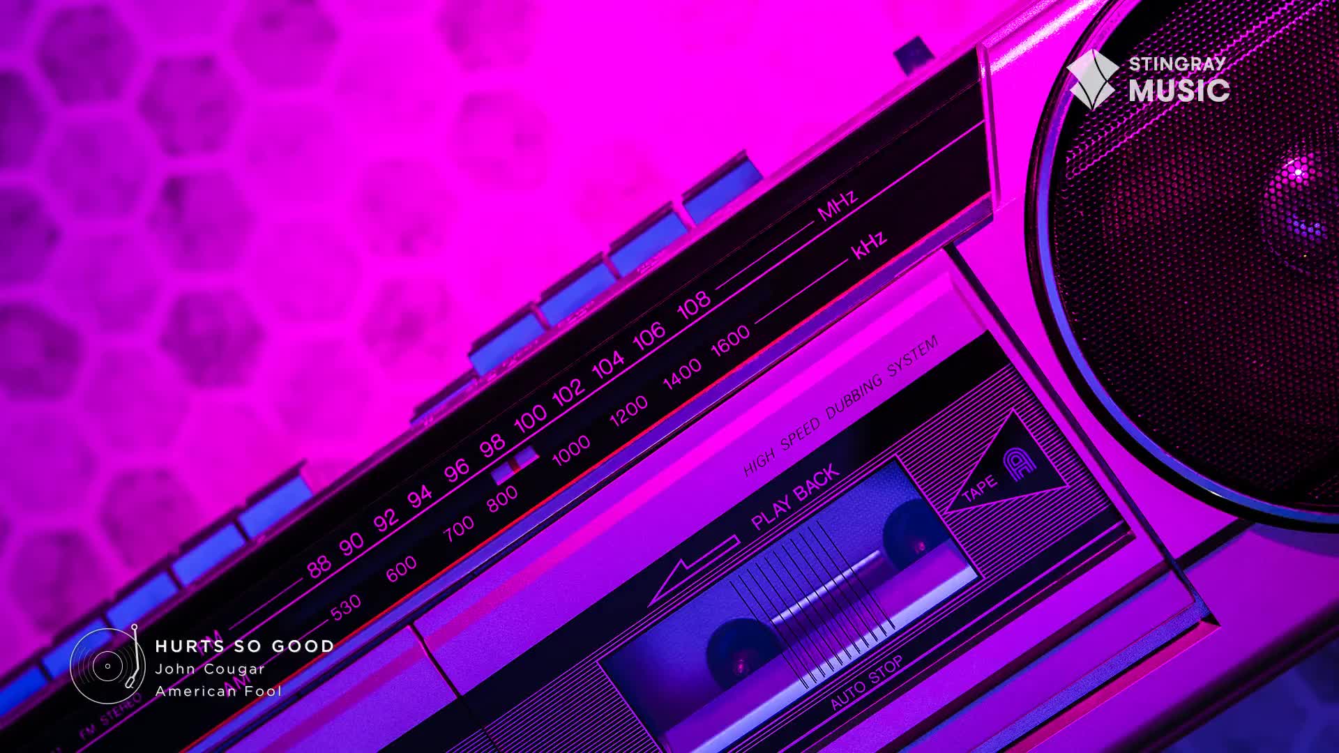 A vintage boombox, bathed in neon purple, is angled towards me. The cassette player is open, and the radio dial is tuned to a station playing tunes from Stingray Everything '80s, likely in Canada.
