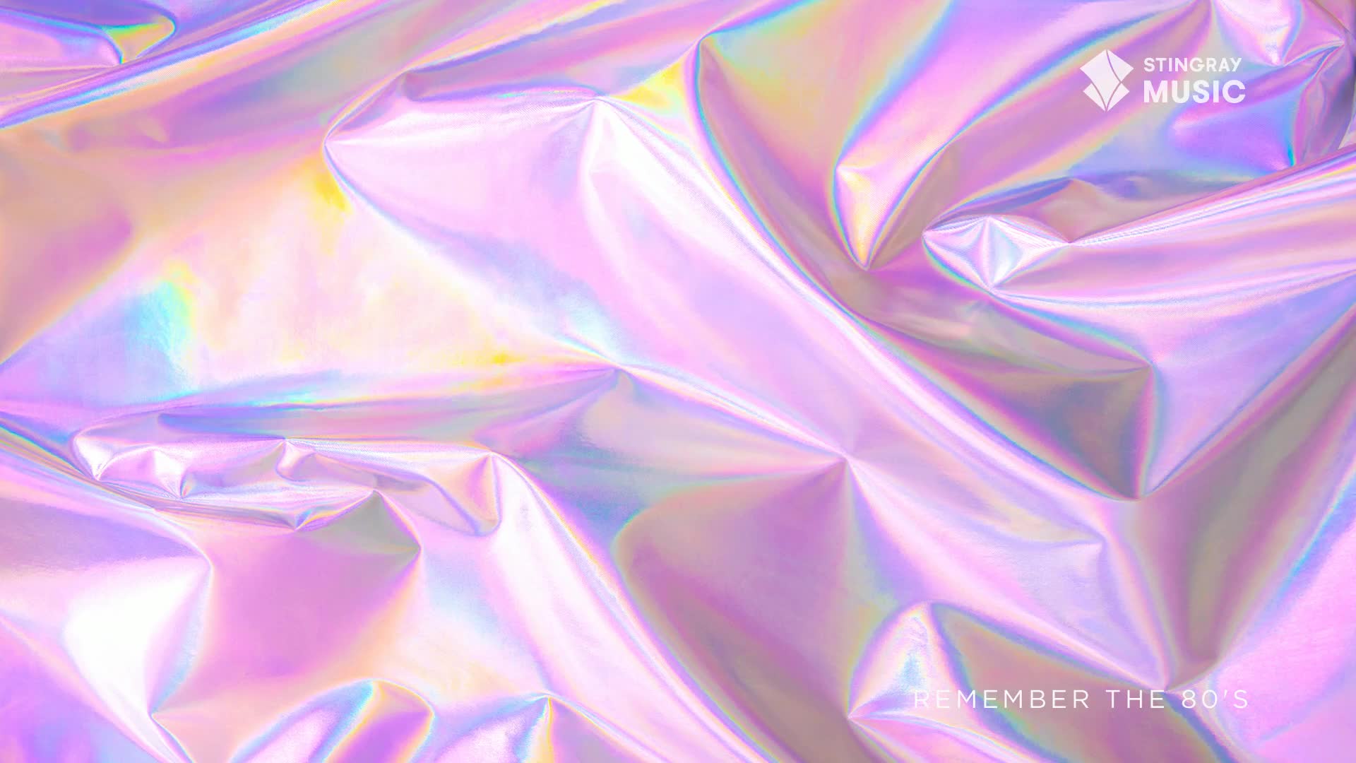 A shimmering, iridescent sheet of material is crumpled, reflecting light in shades of pink, purple, and blue. Reminiscent of the '80s, it's a nostalgic visual for Stingray Everything '80s from Canada.
