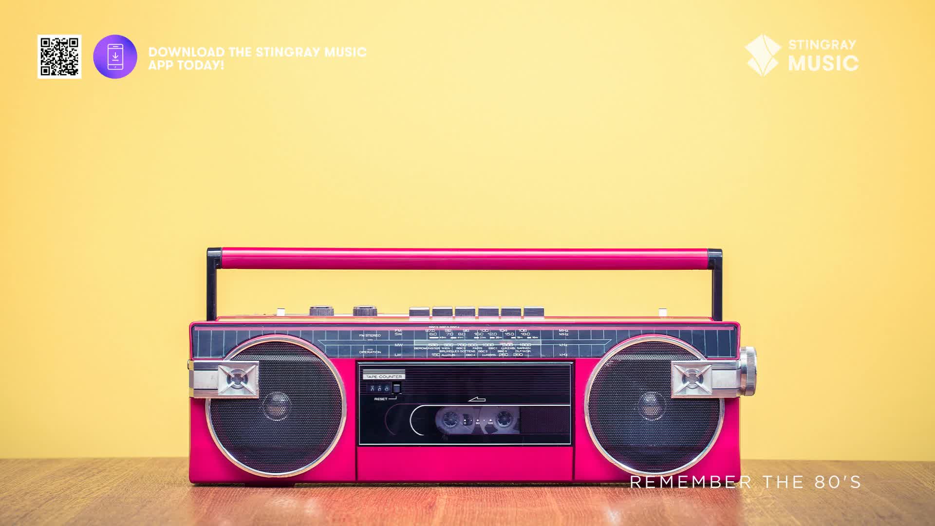 A bright pink boombox sits on a wooden surface, its speakers and cassette player ready for some Stingray Everything '80s. The yellow background and the "Remember the 80's" text evoke a nostalgic feeling of Canada's music scene.
