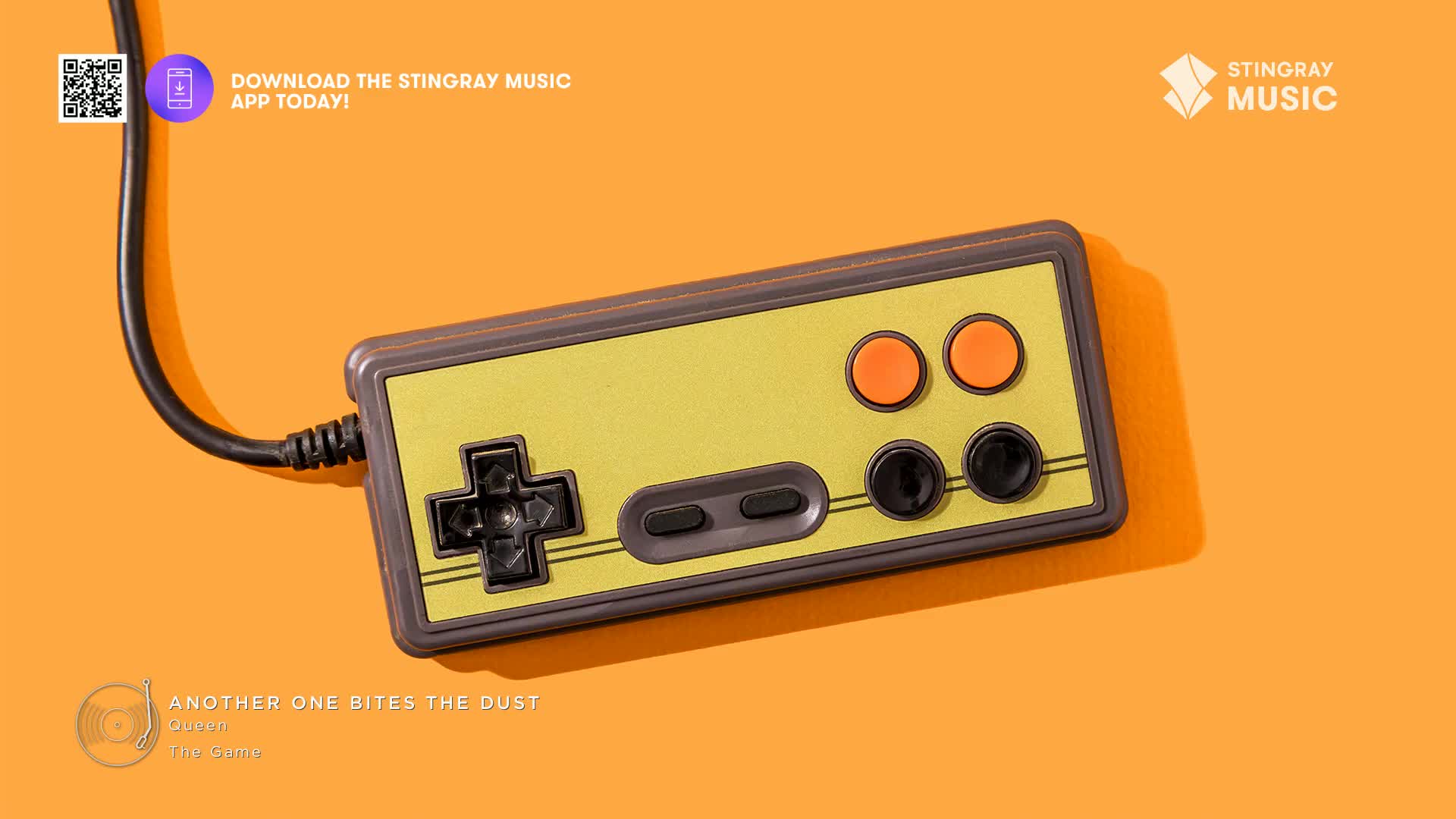 An old-school video game controller rests on an orange surface, its cord extending out of frame. The controller is a throwback, a reminder of the Stingray Everything '80s music playing in the background.
