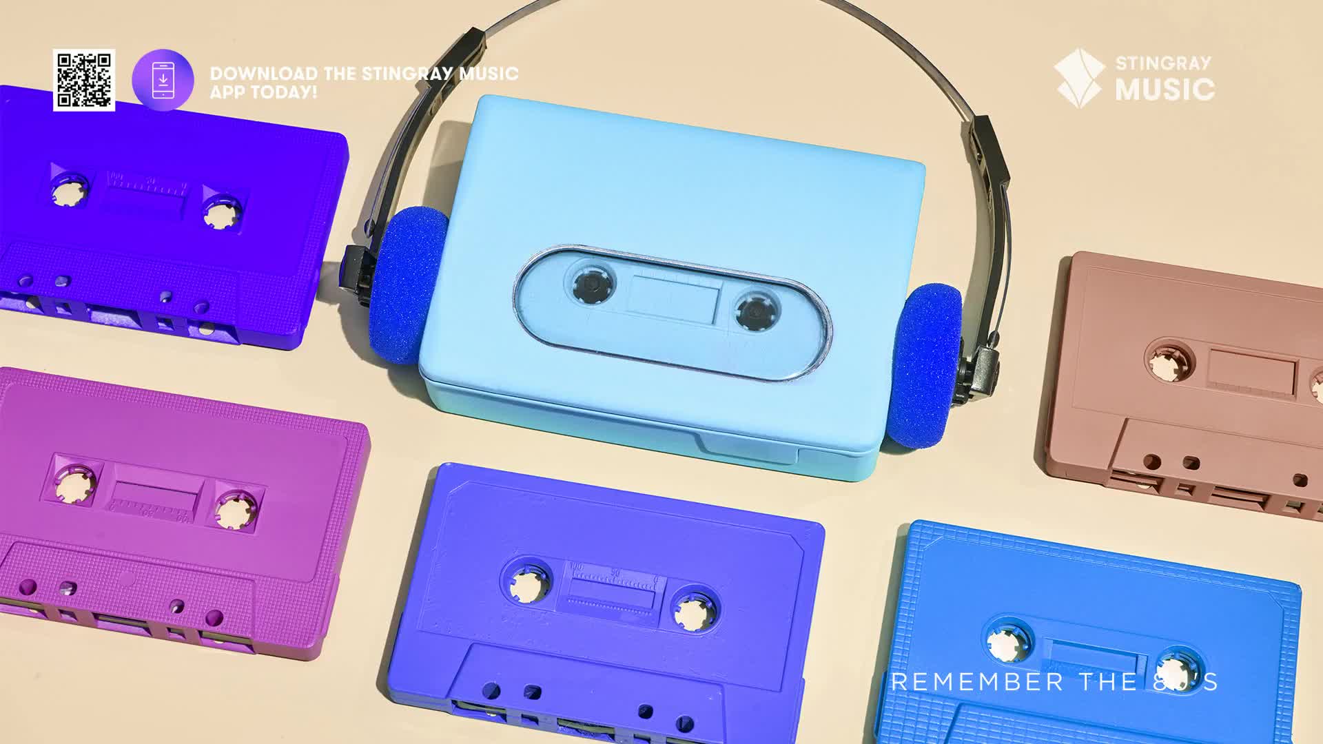 A light blue cassette player sits centered, topped by a pair of headphones. Surrounding it are several brightly colored, solid-toned cassette tapes, ready to play some tunes from the past.
