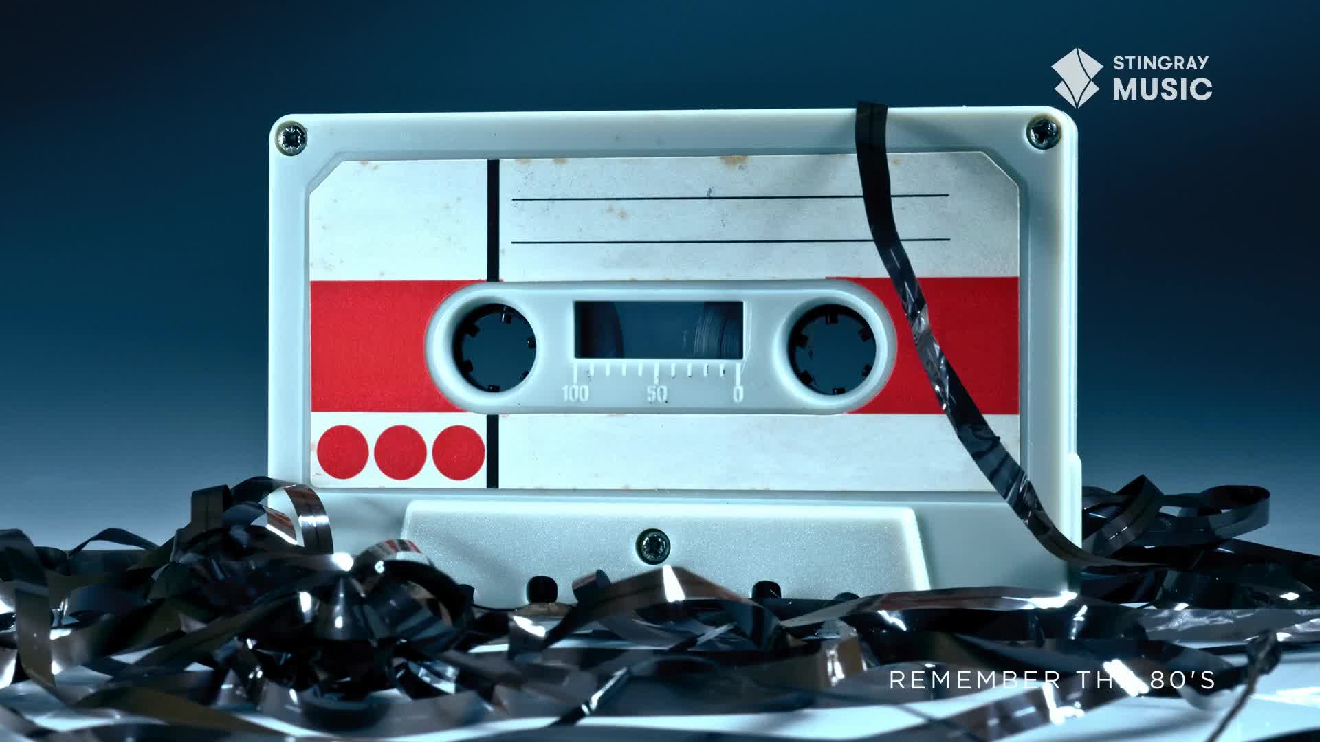 A white cassette tape with red accents sits centered, its black tape spilling out. The Stingray Music logo reminds me of Canada's love for the 80s, and the music that defined a generation.
