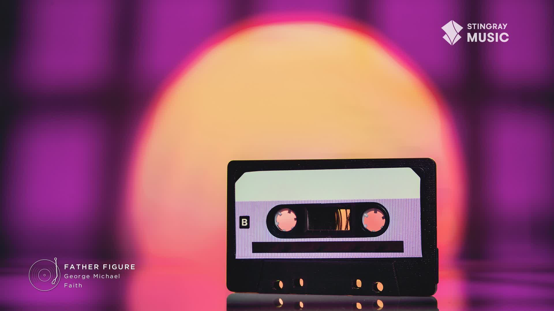 A cassette tape, labeled "B," sits centered against a blurred backdrop of purple and orange. The Stingray Music logo is in the upper right, and the text indicates the song "Father Figure" by George Michael.
A cassette tape, labeled "B," sits centered against a blurred backdrop of purple and orange. The Stingray Music logo is in the upper right, and the text indicates the song "Father Figure" by George Michael.