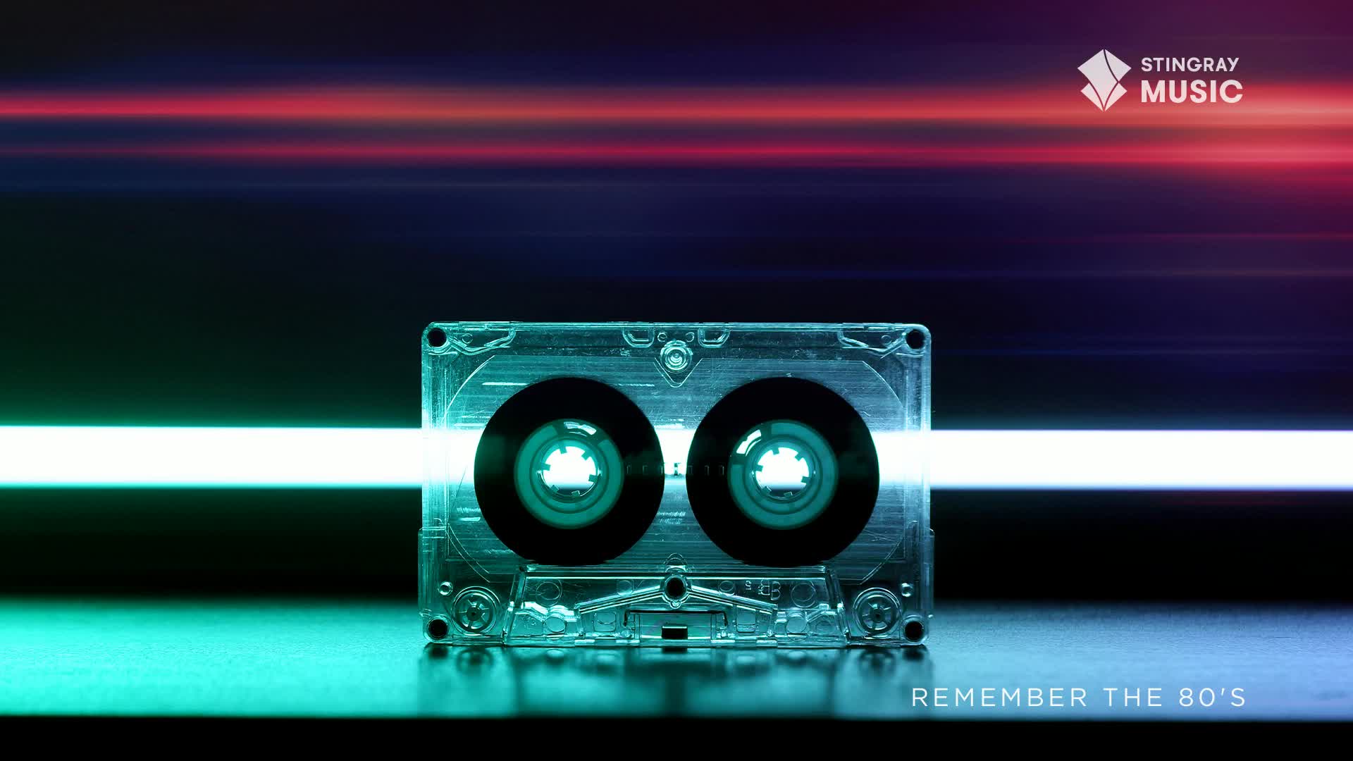A clear cassette tape sits centered, with a bright white beam of light cutting through it. Above, streaks of red and blue light suggest movement, a nod to Stingray Everything '80s and Canada's musical past.
A clear cassette tape sits centered, with a bright white beam of light cutting through it. Above, streaks of red and blue light suggest movement, a nod to Stingray Everything '80s and Canada's musical past.