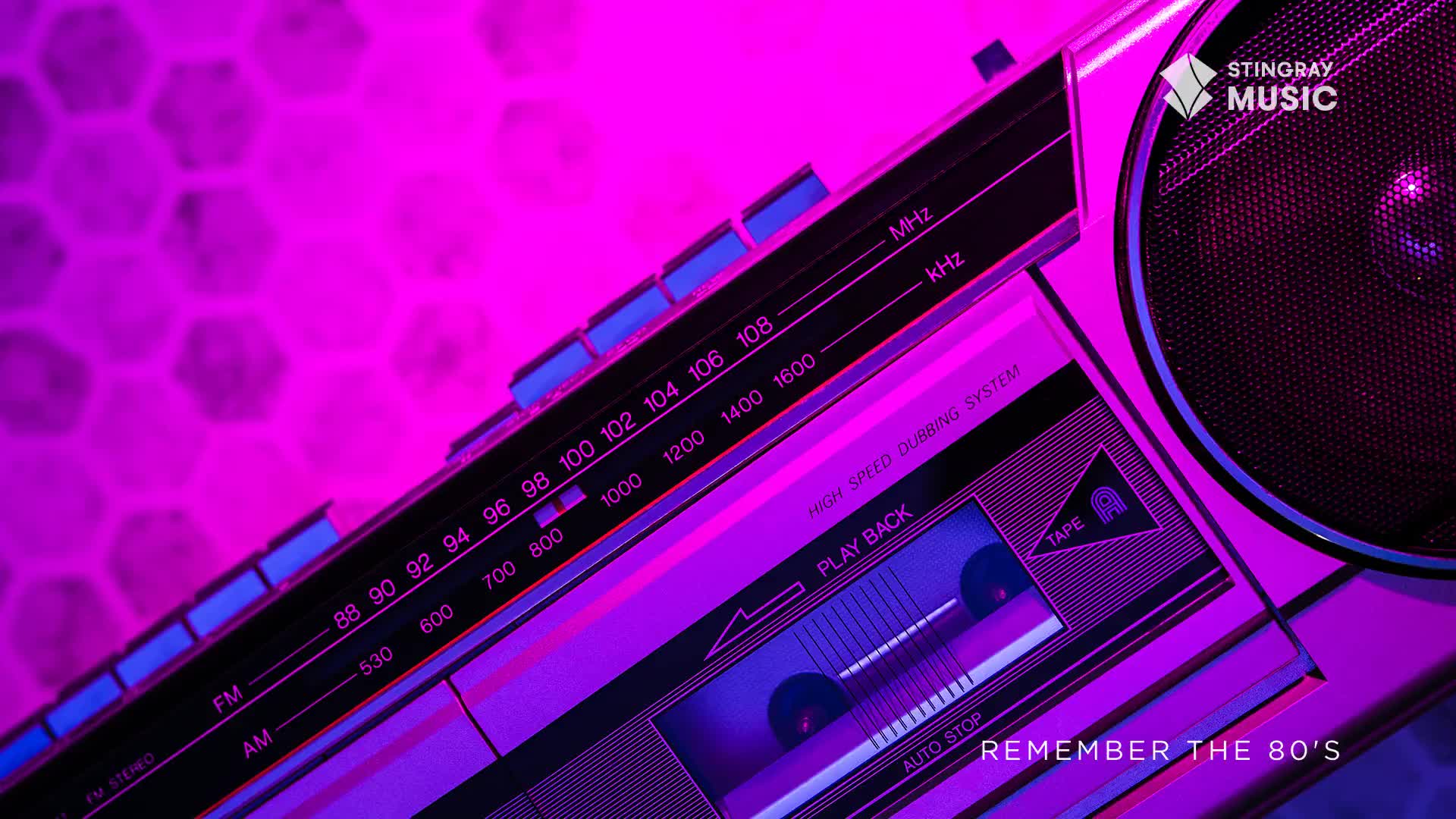 The dial on this 1980s boombox is set to 96 FM, bathed in a vibrant purple glow. A cassette tape sits ready for playback, a reminder of Stingray Music's Everything '80s programming.