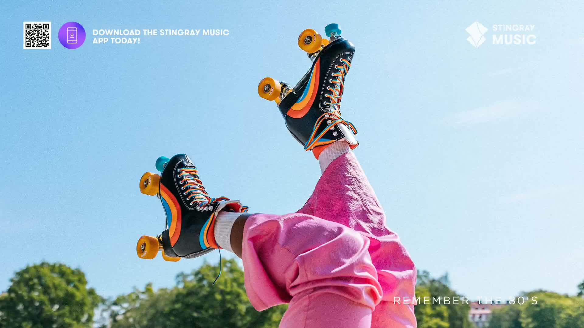Brightly colored roller skates are kicking up in the air against a clear blue sky. It feels like a scene straight out of an '80s music video, maybe even a Canadian summer day.