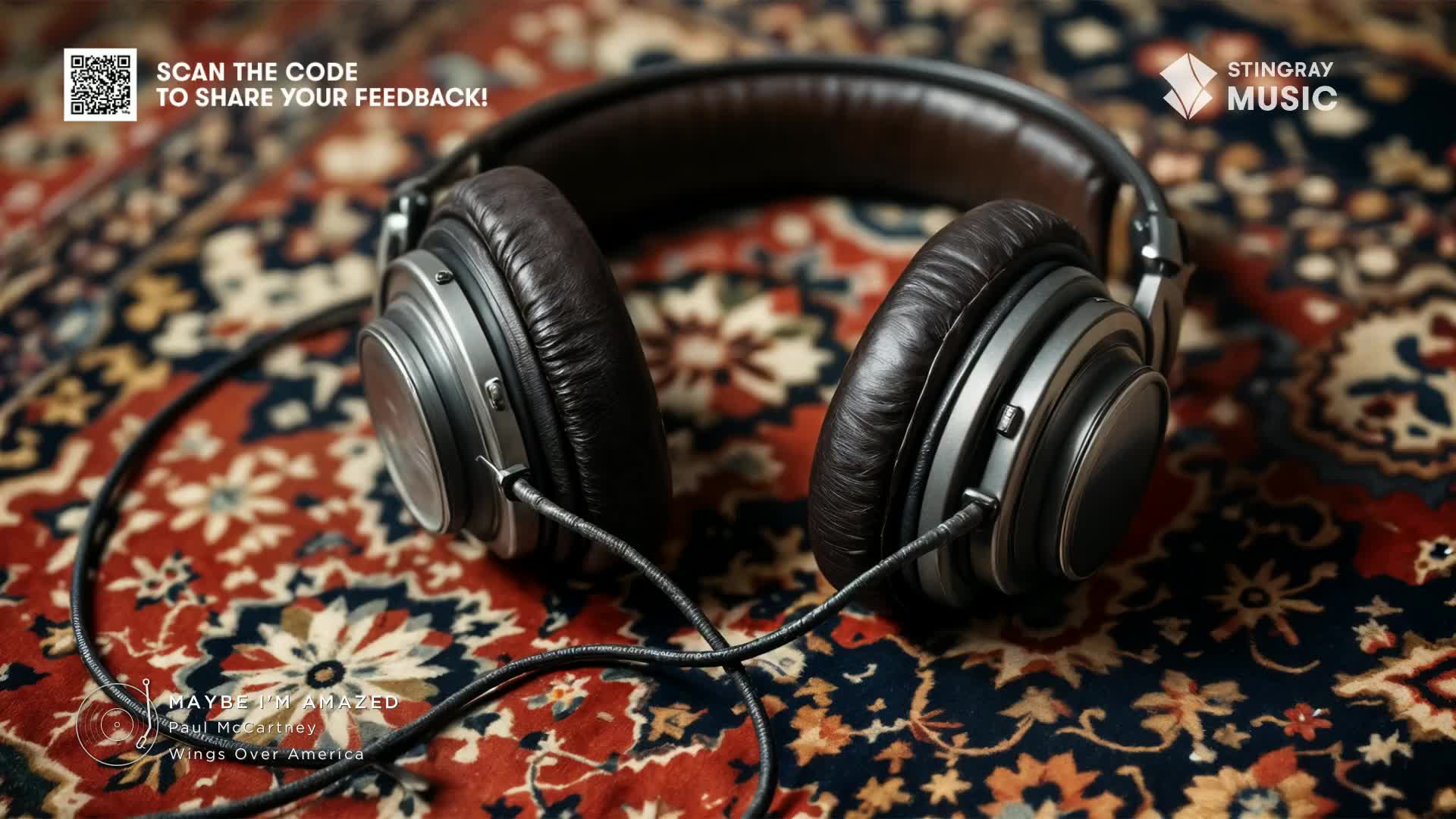 A pair of leather headphones rests on a patterned rug, their cord snaking across the surface. The Stingray Music logo and a QR code hint at the music experience, likely a Canada-based Flashback 70's selection.
