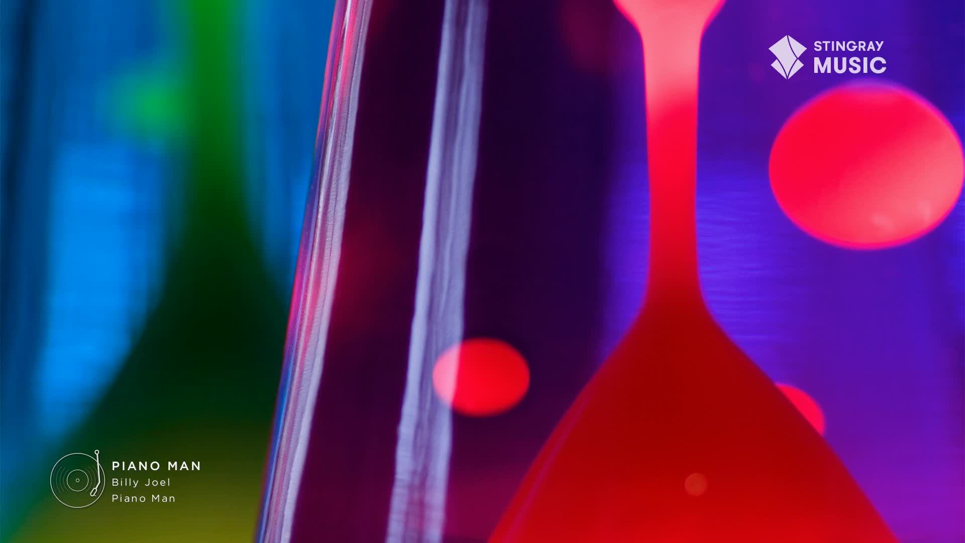 A red, teardrop-shaped light fixture glows against a backdrop of shifting colors, reminiscent of a Stingray Flashback 70's broadcast from Canada. The "Piano Man" logo sits in the corner, hinting at the era's music.
