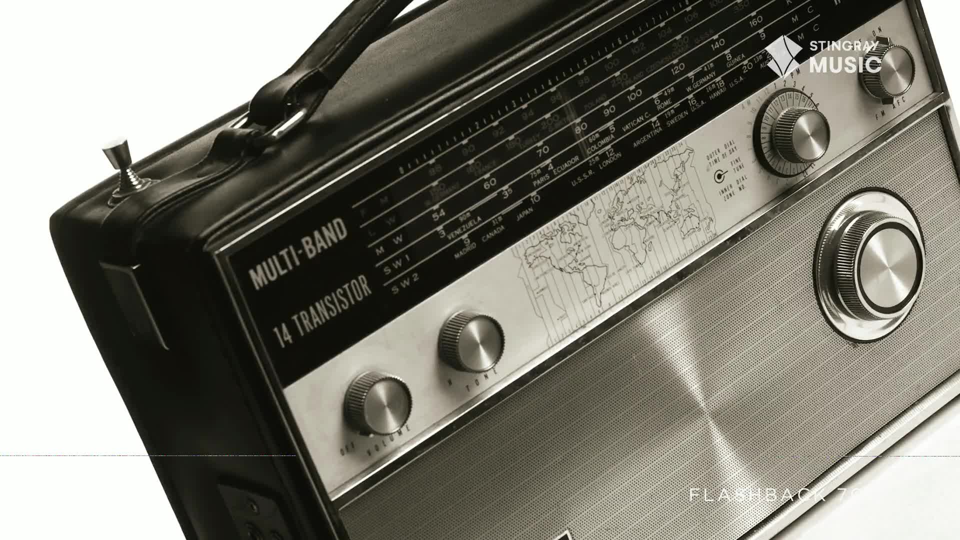 A vintage multi-band transistor radio sits angled, its dials and tuning scale gleaming. The "Stingray Flashback 70's" logo is visible, hinting at a time when this was the way to hear music from Canada and beyond.
