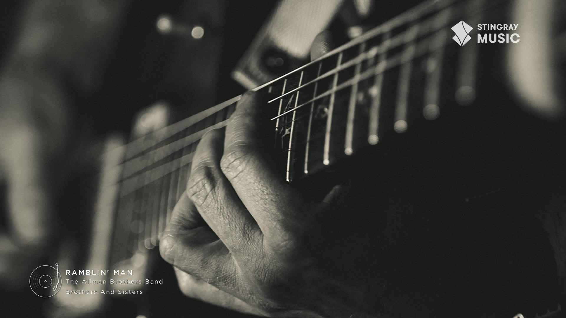 Fingers press down on the strings of a guitar, the hand moving to form chords. The Stingray Flashback 70's broadcast from Canada is bringing the music to life.
