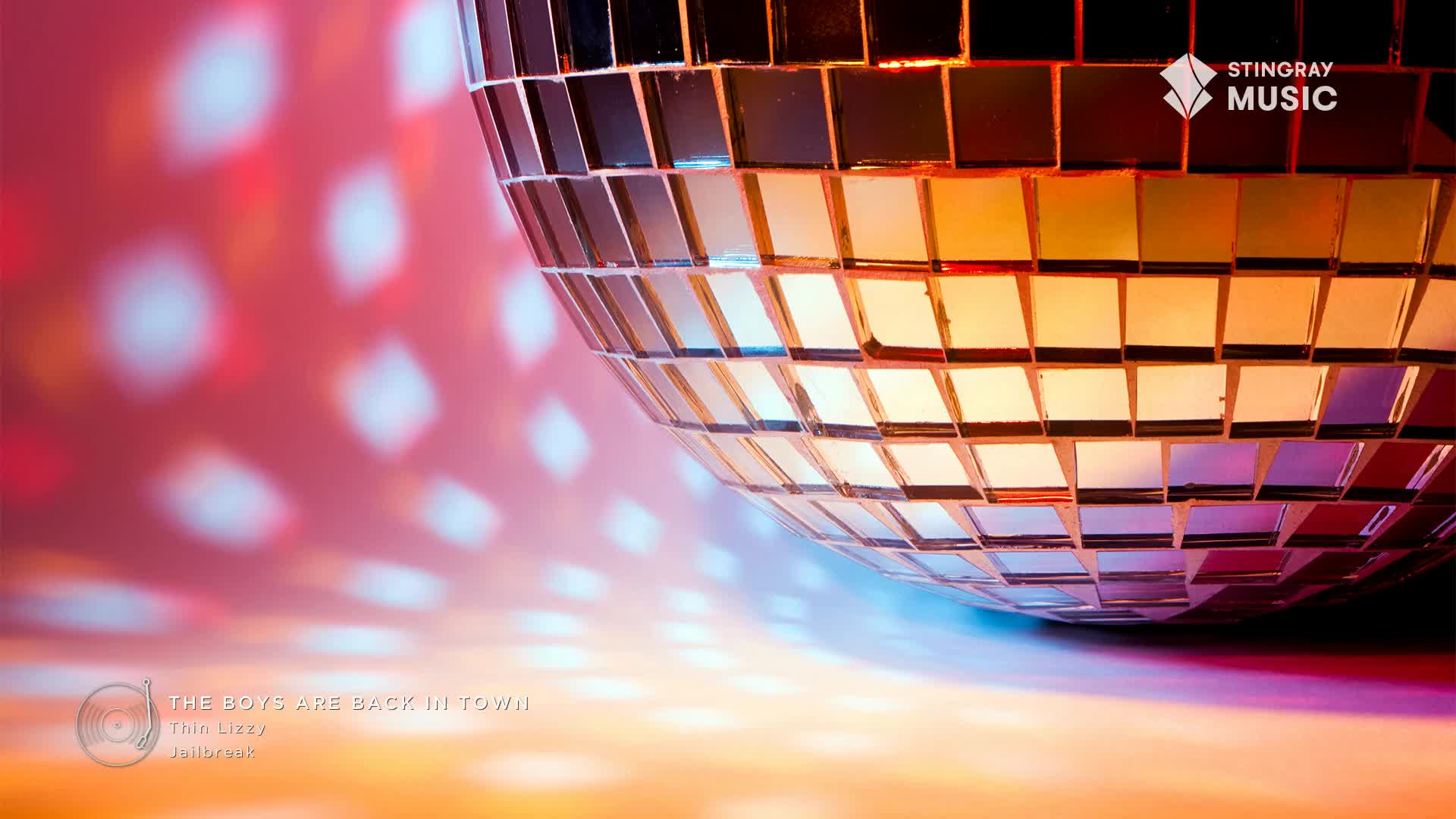 A disco ball is casting diamond-shaped light patterns on the wall. The scene is bathed in warm, retro hues, a perfect backdrop for a Stingray Flashback 70's moment.
