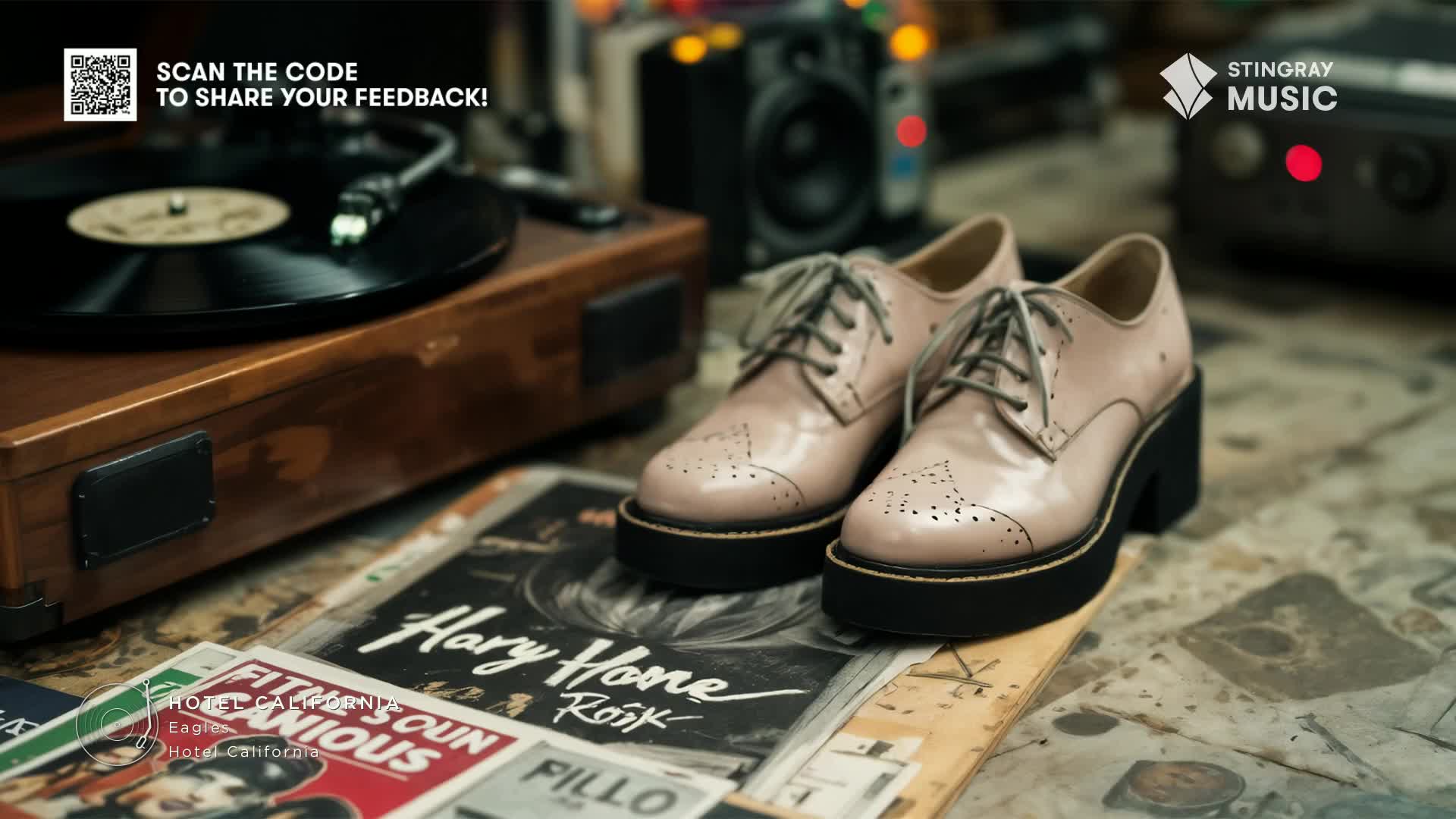 Pale pink shoes with thick black soles sit on top of album covers, a vintage record player in the background. The scene feels like a throwback, maybe a Stingray Flashback 70's vibe from Canada.
