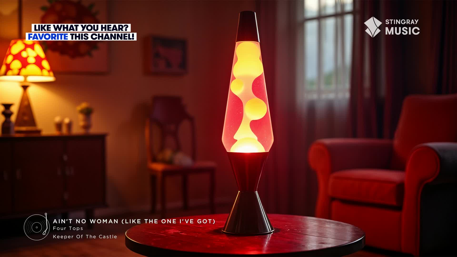 A lava lamp, a relic from the 70s, glows on a round table, its blobby contents slowly shifting. The Stingray Flashback 70's channel from Canada is playing, setting a groovy mood.
