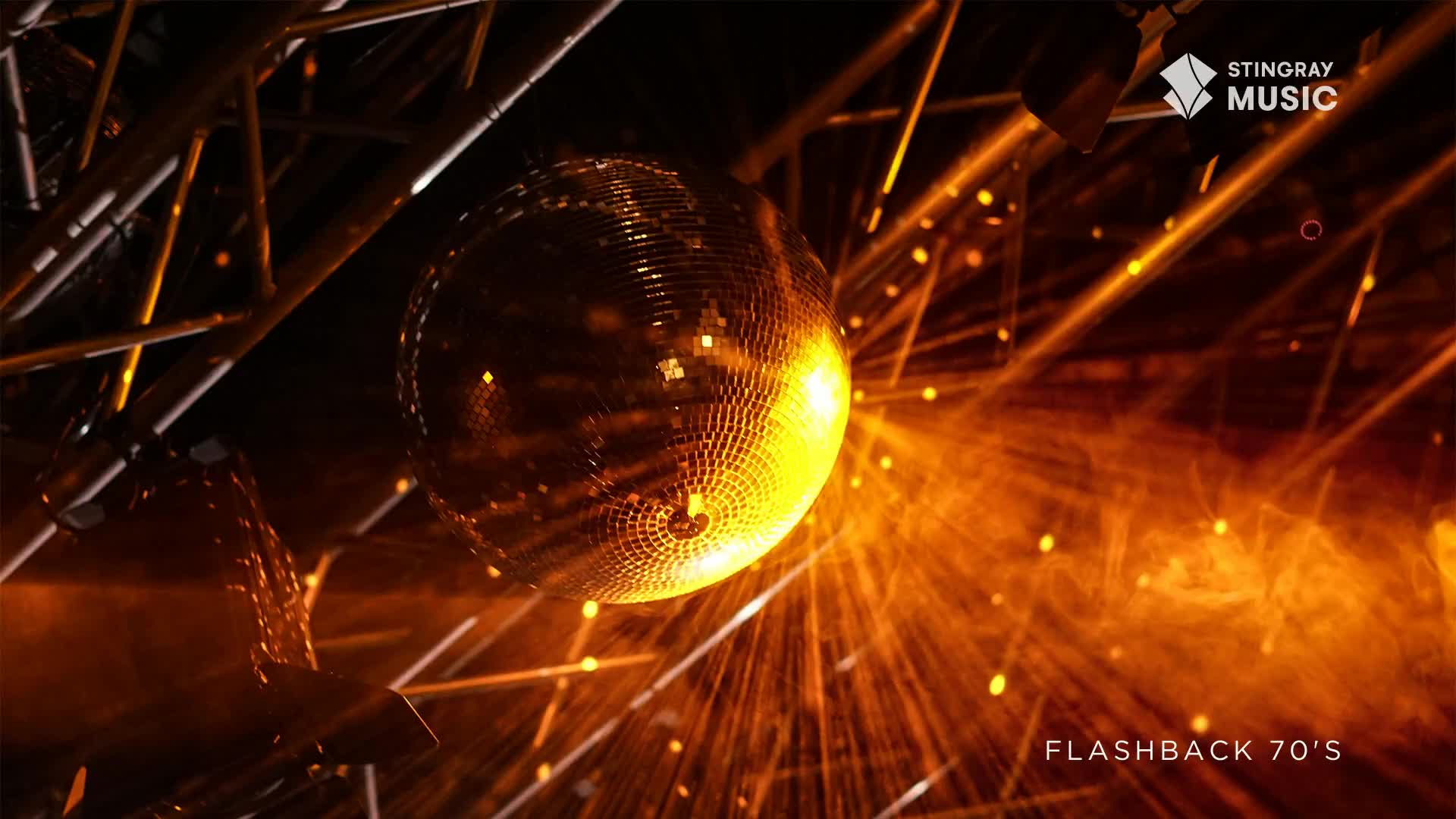 A mirrored ball is suspended, catching the light and scattering it across the scene. The warm, amber glow evokes a Stingray Flashback 70's vibe, a classic Canadian disco experience.
