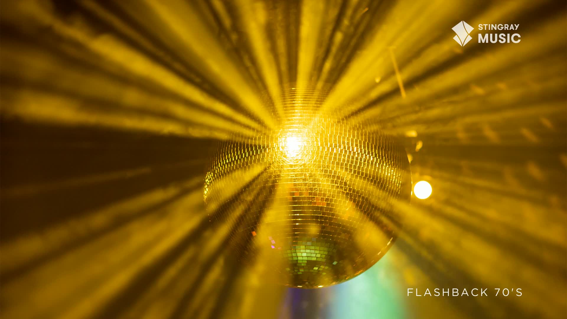 A mirrored disco ball hangs, reflecting a bright yellow light that radiates outwards like a sunburst. The scene feels like a Stingray Flashback to the 70s, with a warm, inviting glow.
