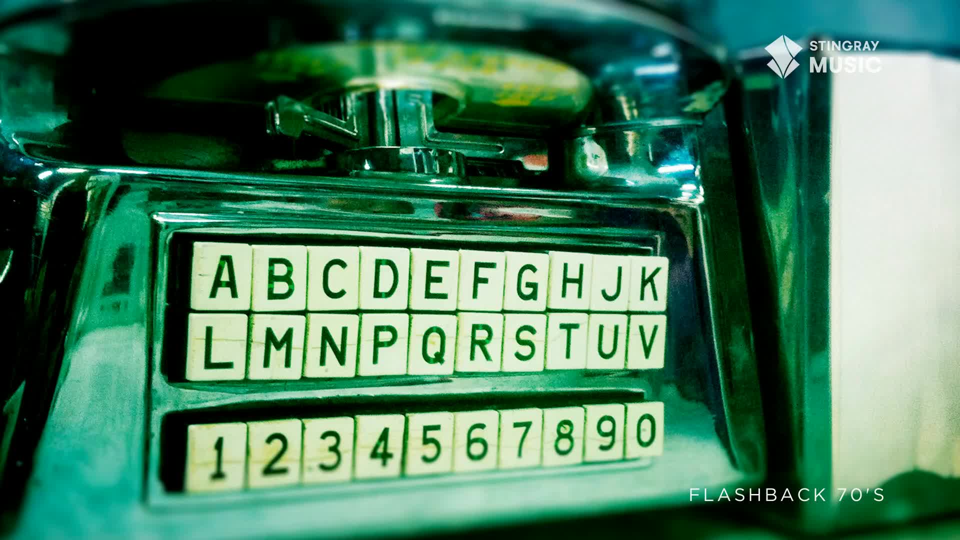 The chrome gleams under the dim lights of this Canadian diner, the letter and number buttons on the jukebox waiting for a selection. A faint green hue washes over the scene, hinting at the era of classic rock and roll.
