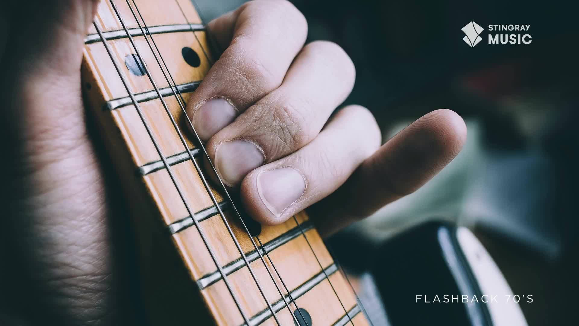 Fingers press down on the fretboard, ready to strum a classic riff. The maple neck and steel strings of this electric guitar evoke a sound that defined a generation of Canadian music.