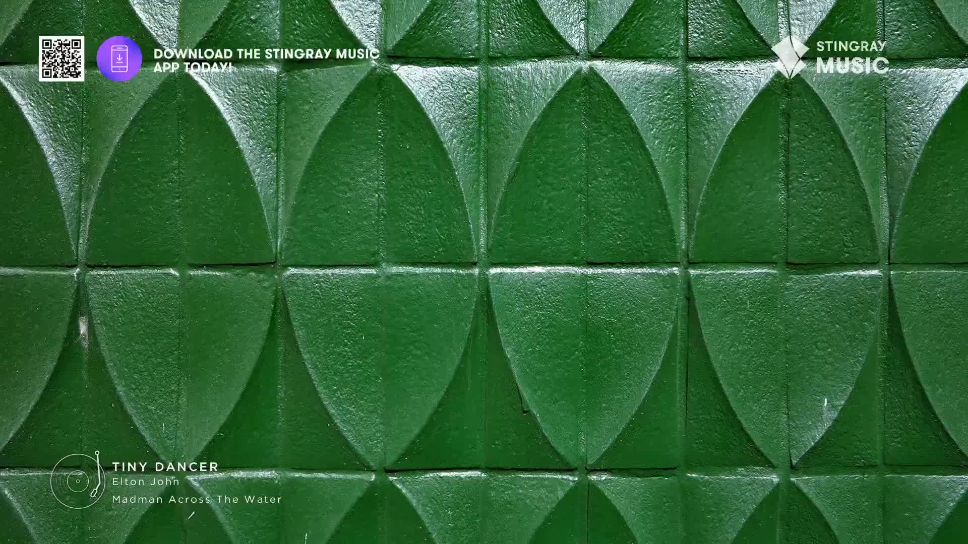 The Stingray Music app is available for download, featuring Elton John's "Tiny Dancer" from *Madman Across the Water*. This retro Canadian soundtrack plays against a textured green wall.