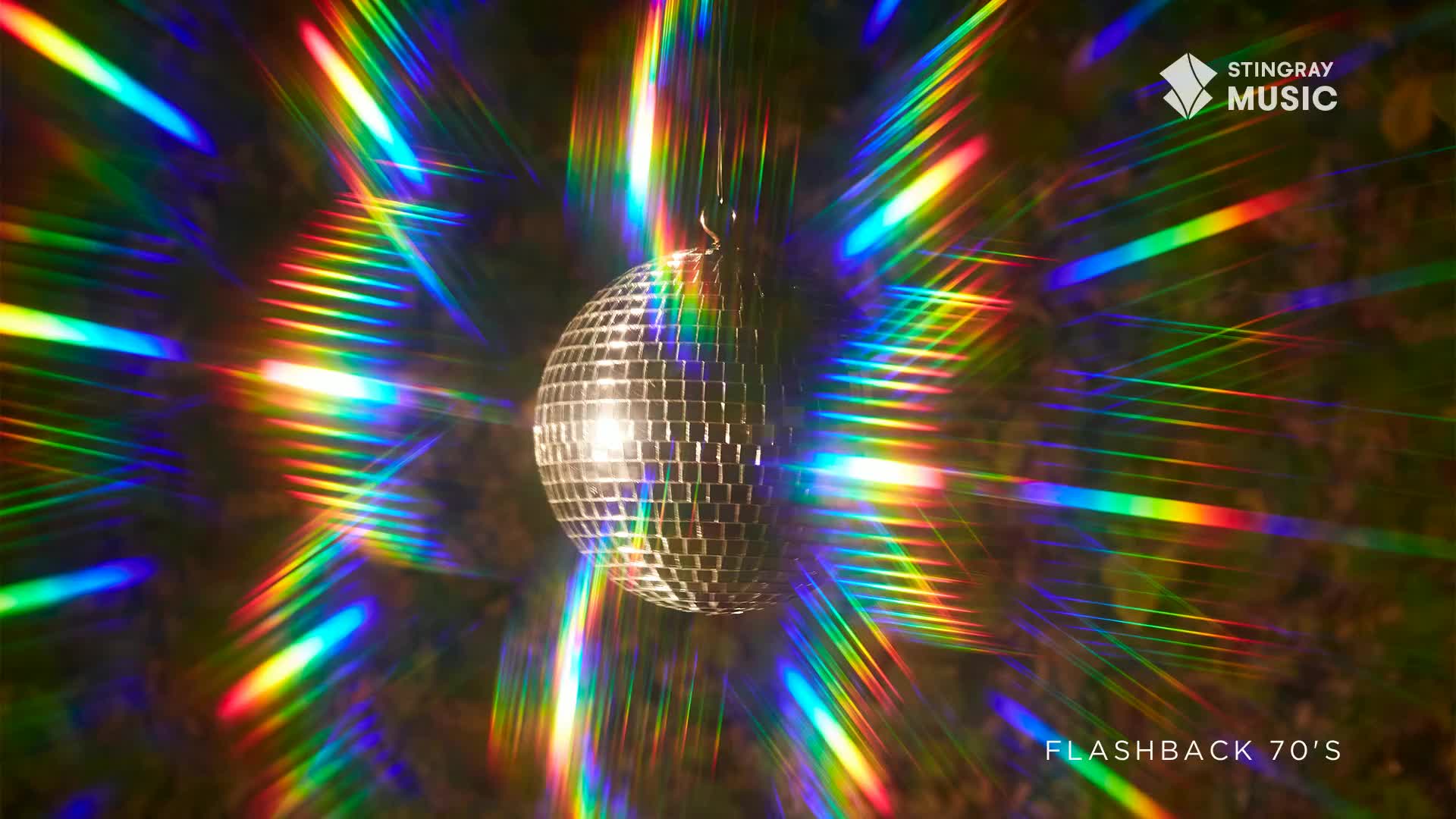 A disco ball hangs, catching the light and sending rainbow beams across the dark. It feels like a Saturday night in a Toronto club, circa 1977.