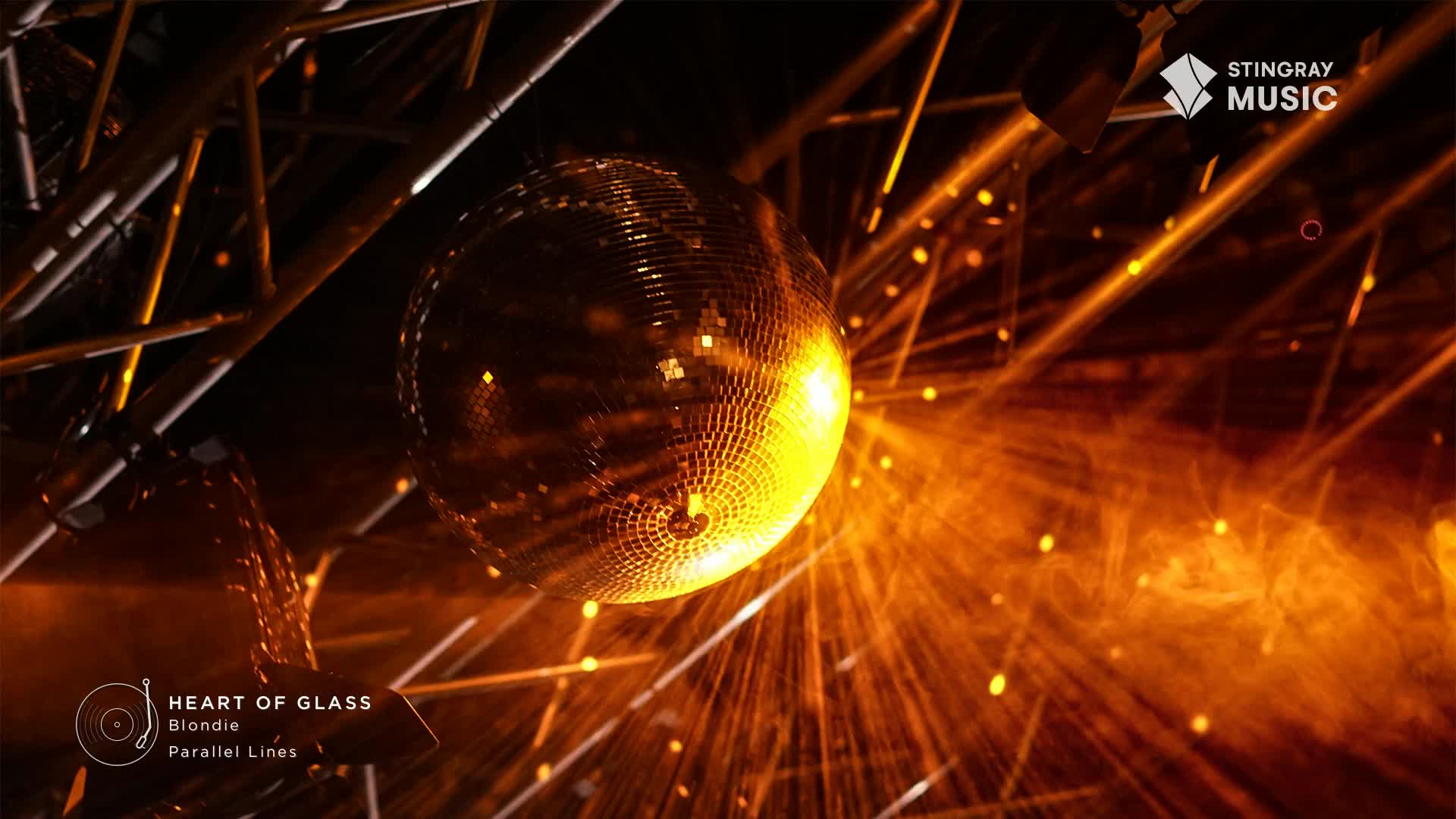 The mirrored ball spins, catching the orange light and sending it out in sharp beams.  This feels like a flashback to a 70's dance floor in Canada.