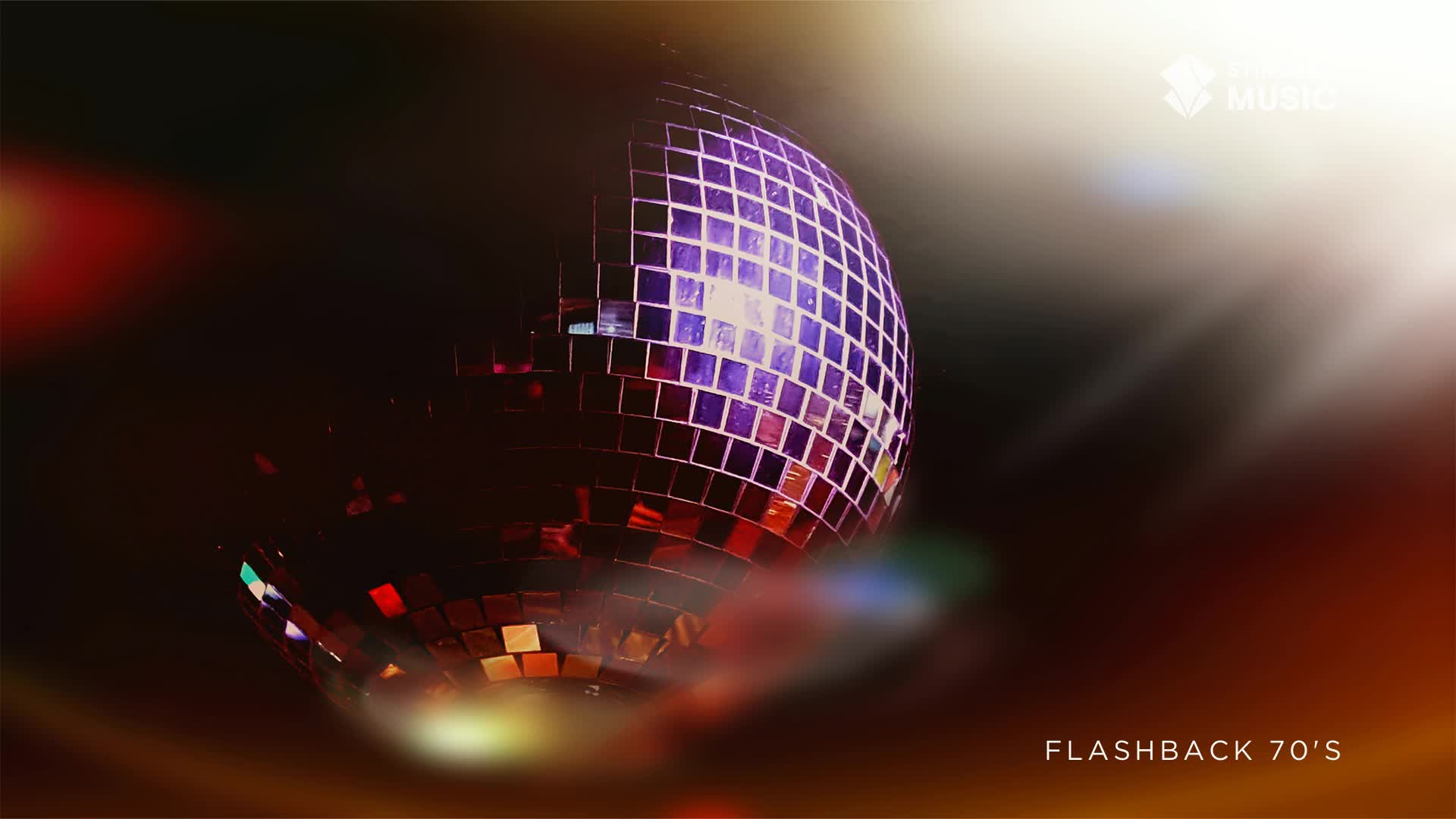 The disco ball spins, its mirrored facets catching the light and sending purple and red reflections across the dark room. It feels like a Saturday night in a Canadian club, back in the 70s.