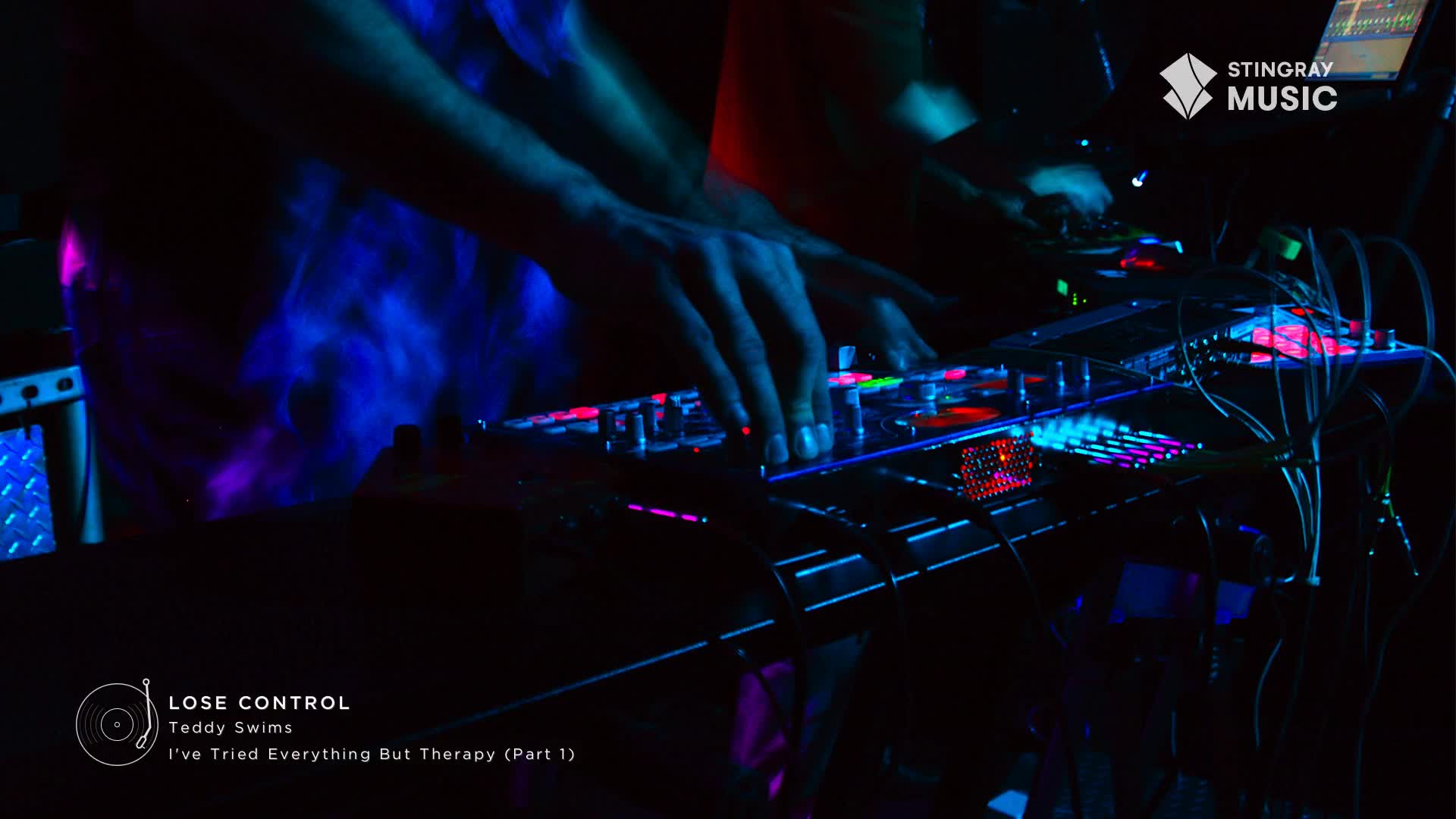 A DJ's hands are moving across the illuminated controls, bathed in blue and purple light. The Stingray Hit List logo in the corner confirms this is a Canadian music event.
