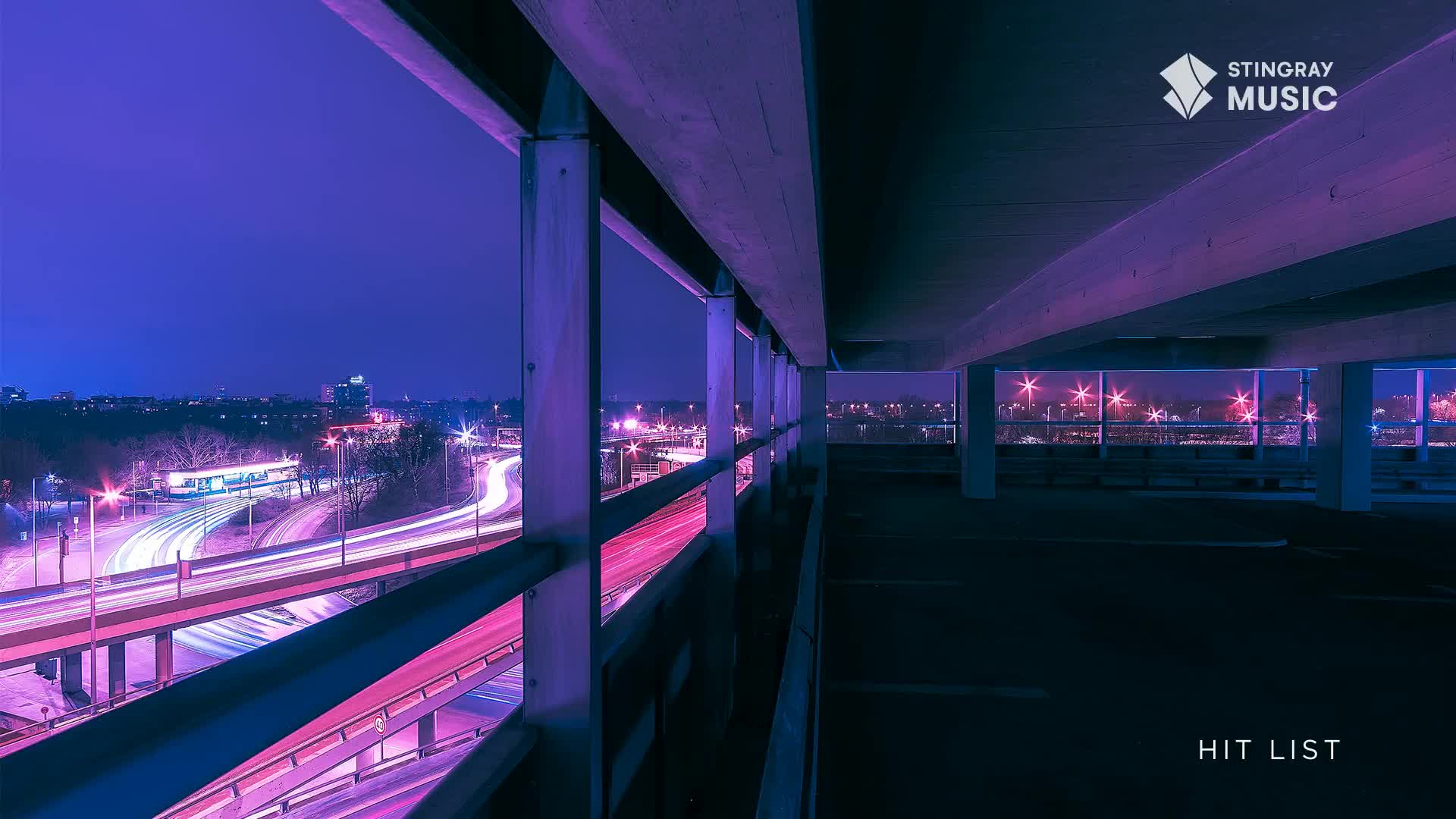 From this parking structure in Canada, the highway below is a river of light, streaks of red and white flowing into the night. The Stingray Hit List logo sits in the corner, a reminder of the music that's probably playing in the cars below.
