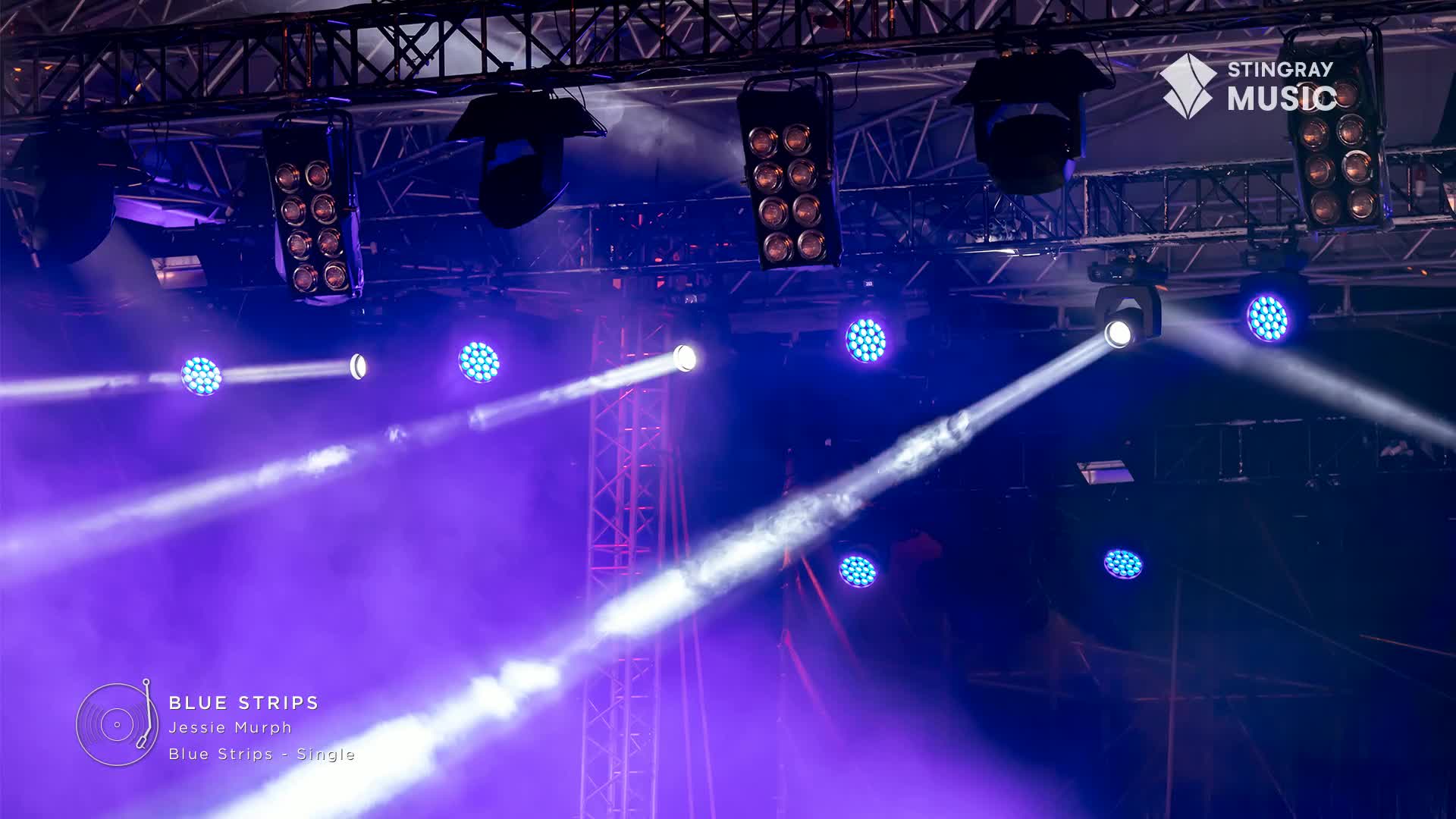 The stage is awash in blue light, with beams cutting through the haze from the overhead fixtures. It's a Stingray Hit List show, and the lights are set for Jessie Murph's "Blue Strips."
