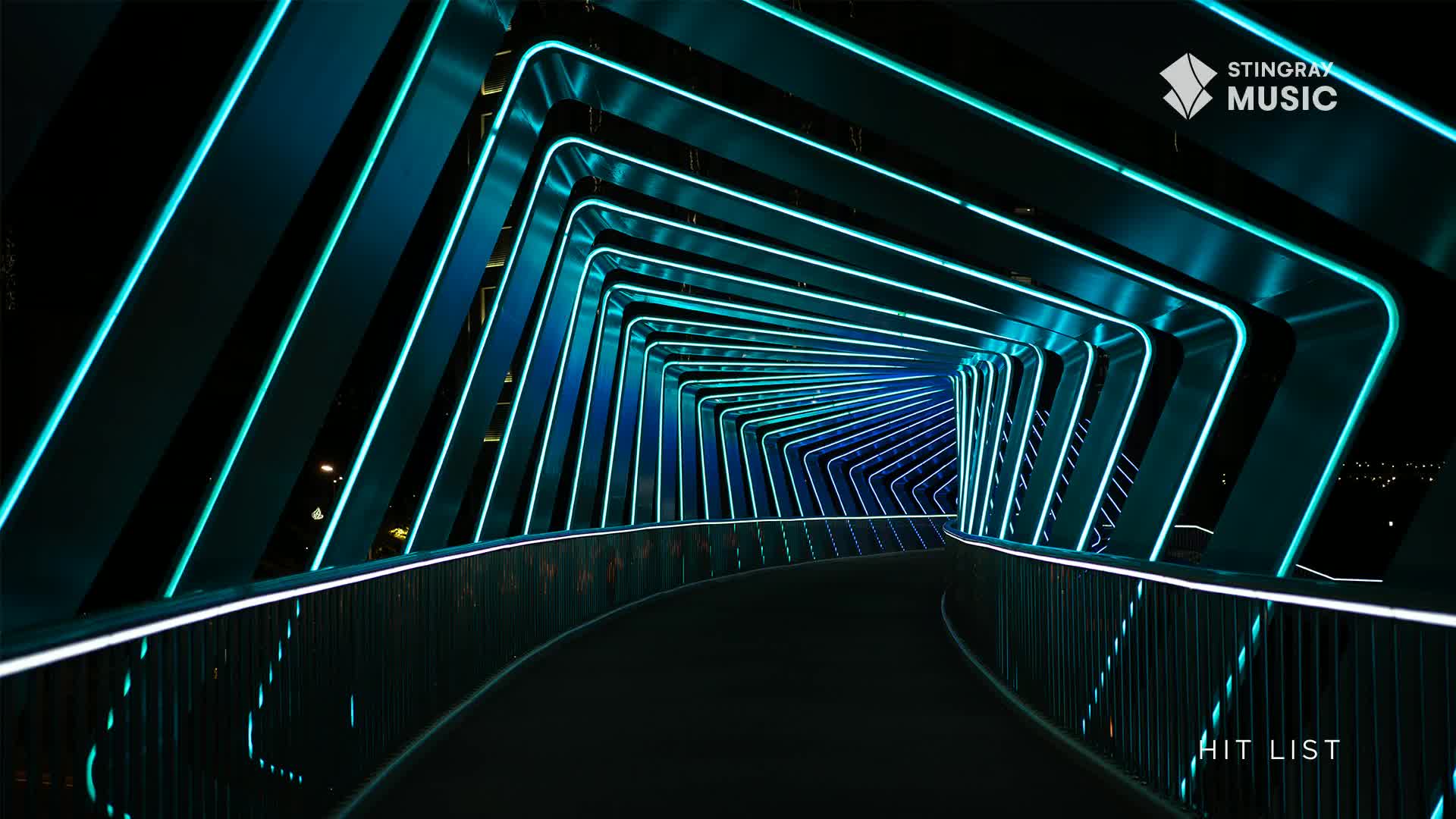 A curved walkway disappears into a tunnel of glowing teal lines, a modern design that feels futuristic. The Stingray Music logo sits in the corner, and the "Hit List" branding is visible at the end of the tunnel.
