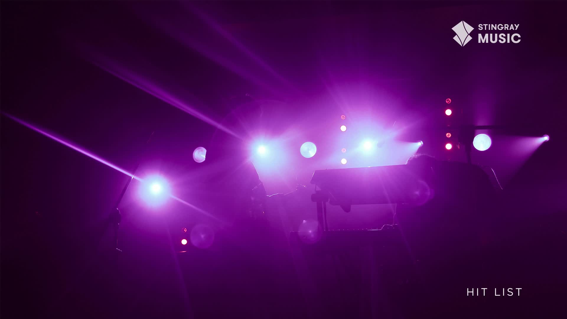 Bright purple stage lights are beaming across the stage, illuminating a keyboard and the silhouettes of performers. It's a Stingray Hit List concert, and the energy is building.
