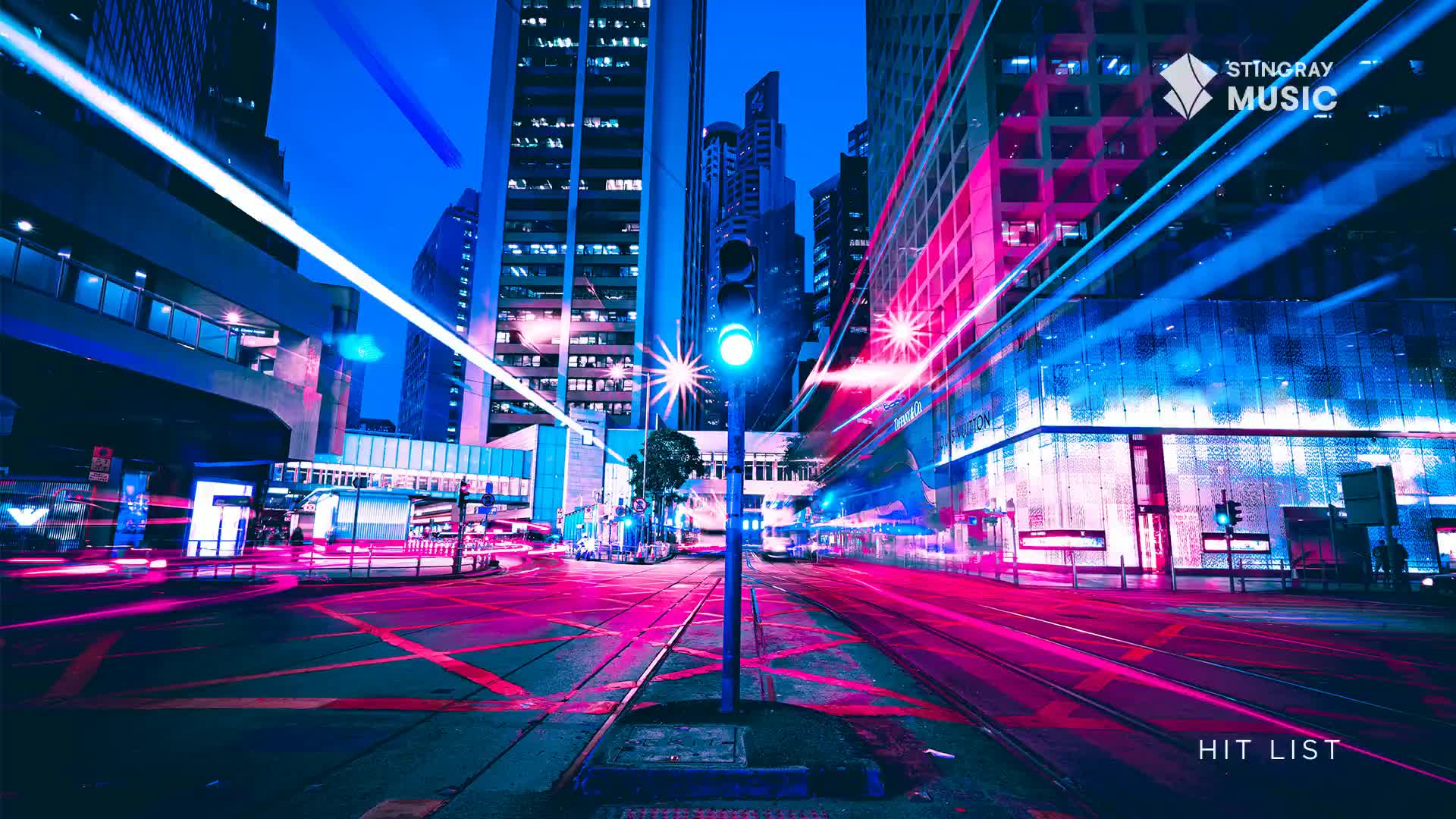 Neon streaks of magenta and blue light race across the cityscape, while the traffic light glows a steady green. The Stingray Hit List is showing off the energy of Canada's night life.
