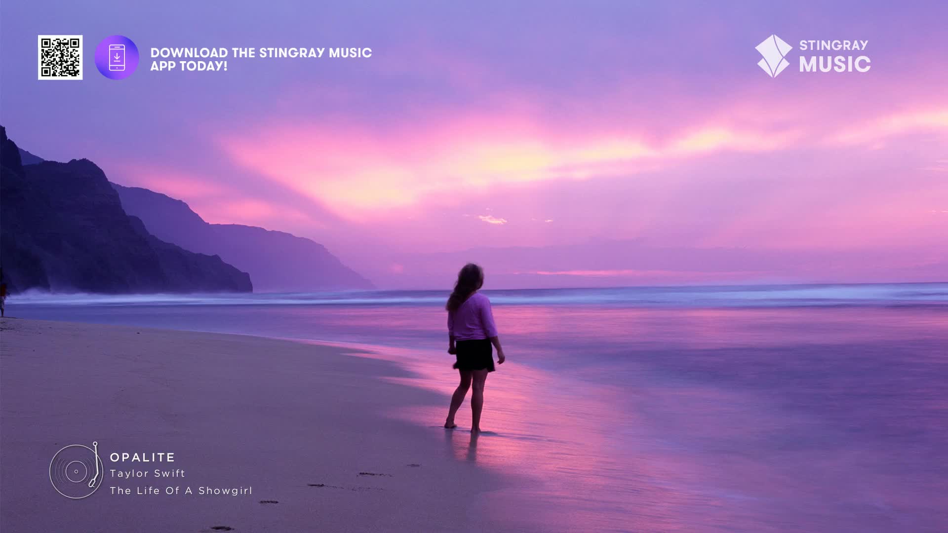 The sky glows with a vibrant purple and pink as gentle waves lap the shore. A lone figure stands at the water's edge, silhouetted against the dramatic sunset.