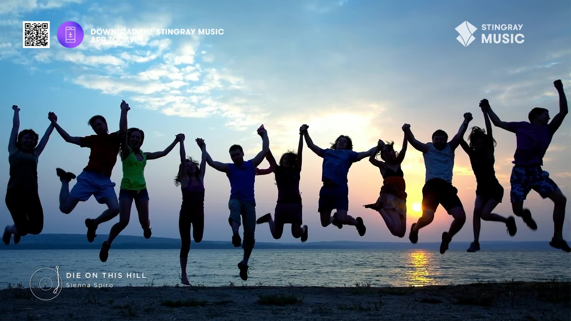 A group of friends leaps in unison, hands linked, against a Canadian sunset. Their silhouettes are stark against the sky as they reach for the sky.