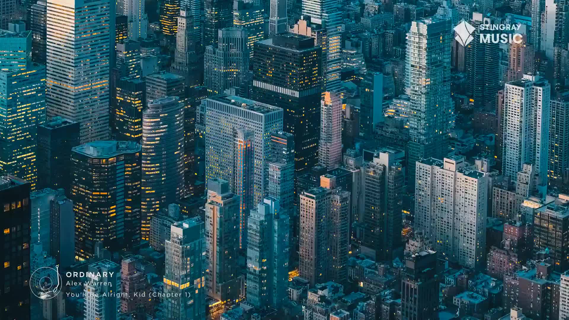 The city lights are on, illuminating the towering buildings of downtown Toronto. A Stingray Music logo appears over the skyline, advertising "Ordinary" by Alex Warren.