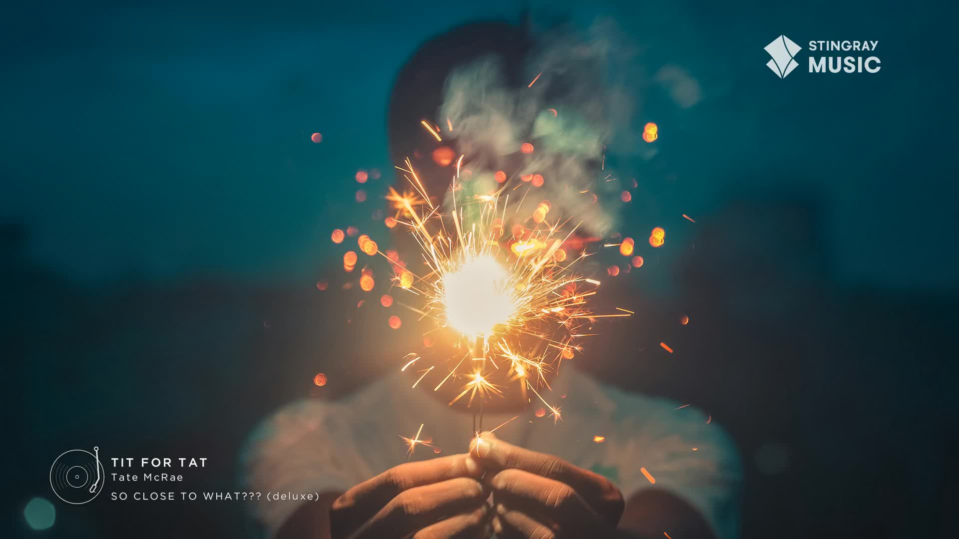 A sparkler flares brightly, sending a shower of orange embers into the dusky Canadian air. Tate McRae's "Tit For Tat" is playing, a Stingray Hit List track.