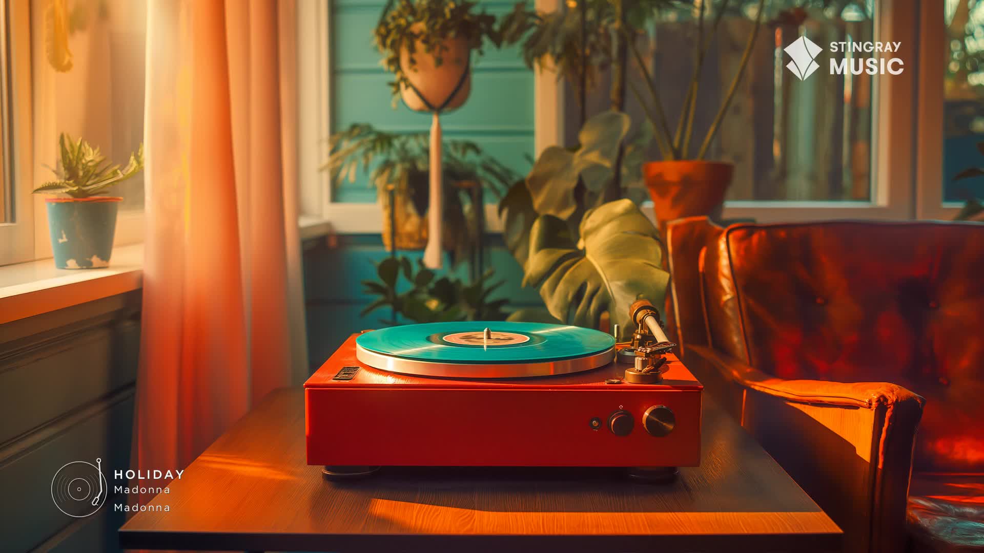 A red record player sits on a wooden table, the turquoise vinyl spinning. Sunlight streams through the window, illuminating the scene and the Stingray Holiday Hits logo.
