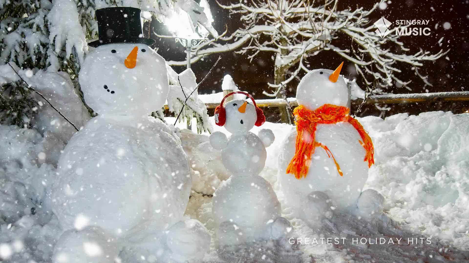 Snowflakes drift gently around three snowmen, one wearing a top hat, another a bright orange scarf, and the smallest, some earmuffs. It's a scene you'd expect to see on a Stingray Holiday Hits promo in Canada.
