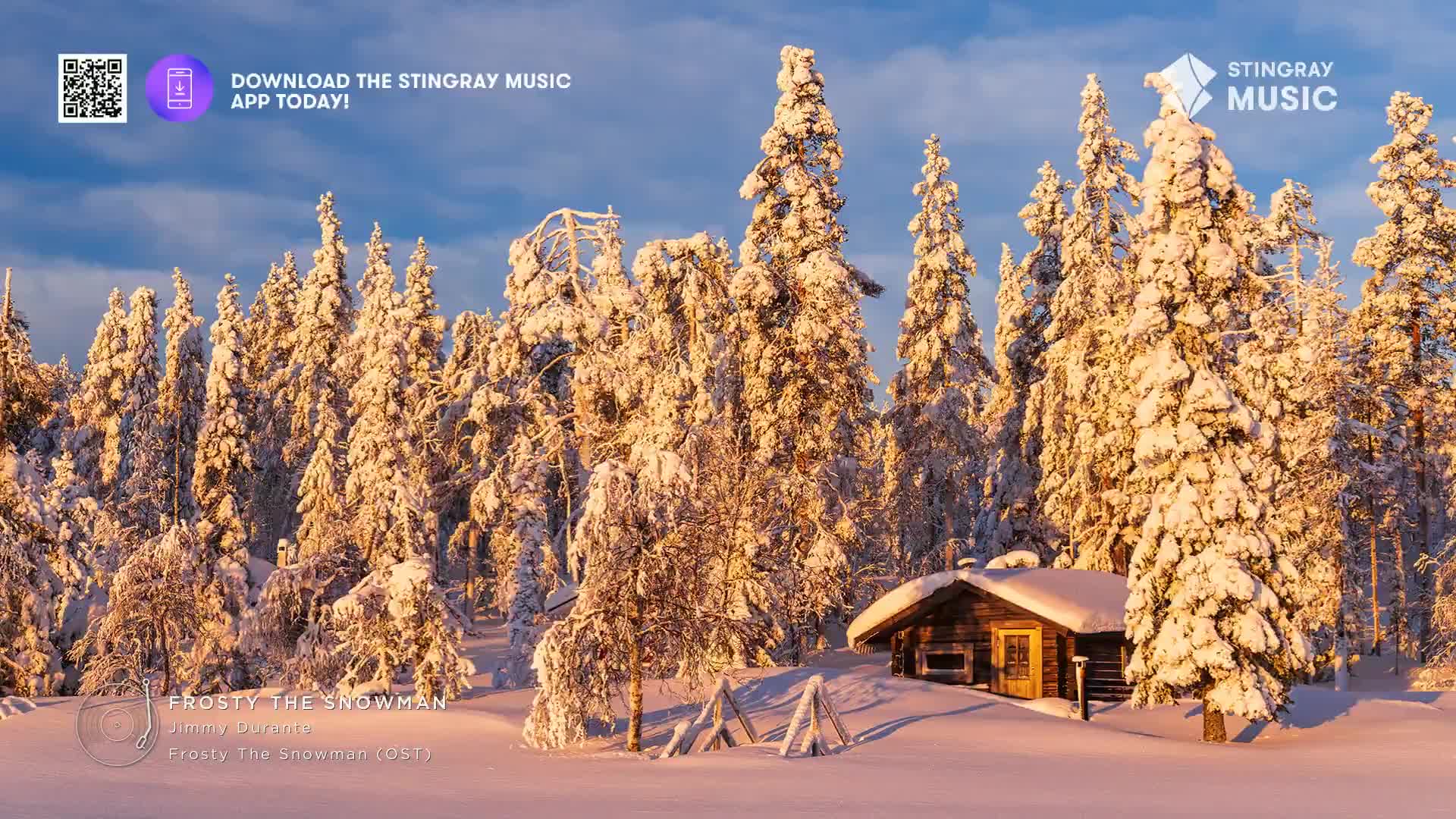 The sun bathes the snow-covered trees and a small cabin in a warm glow. It's a serene scene, like something from a Canadian holiday special on Stingray Music.
