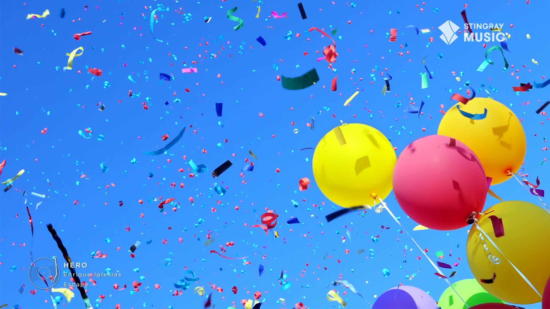 Confetti rains down as a cluster of bright balloons ascend into the clear blue sky. It feels like a true Canadian holiday celebration.