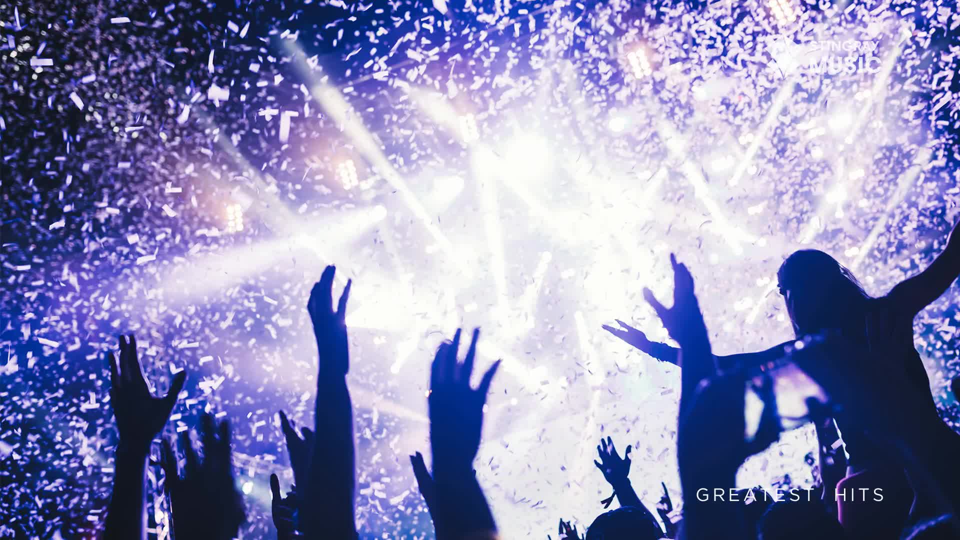 Confetti rains down on raised hands as bright lights pierce the smoky air. The crowd is lost in the moment, celebrating something special from Stingray Holiday Hits.