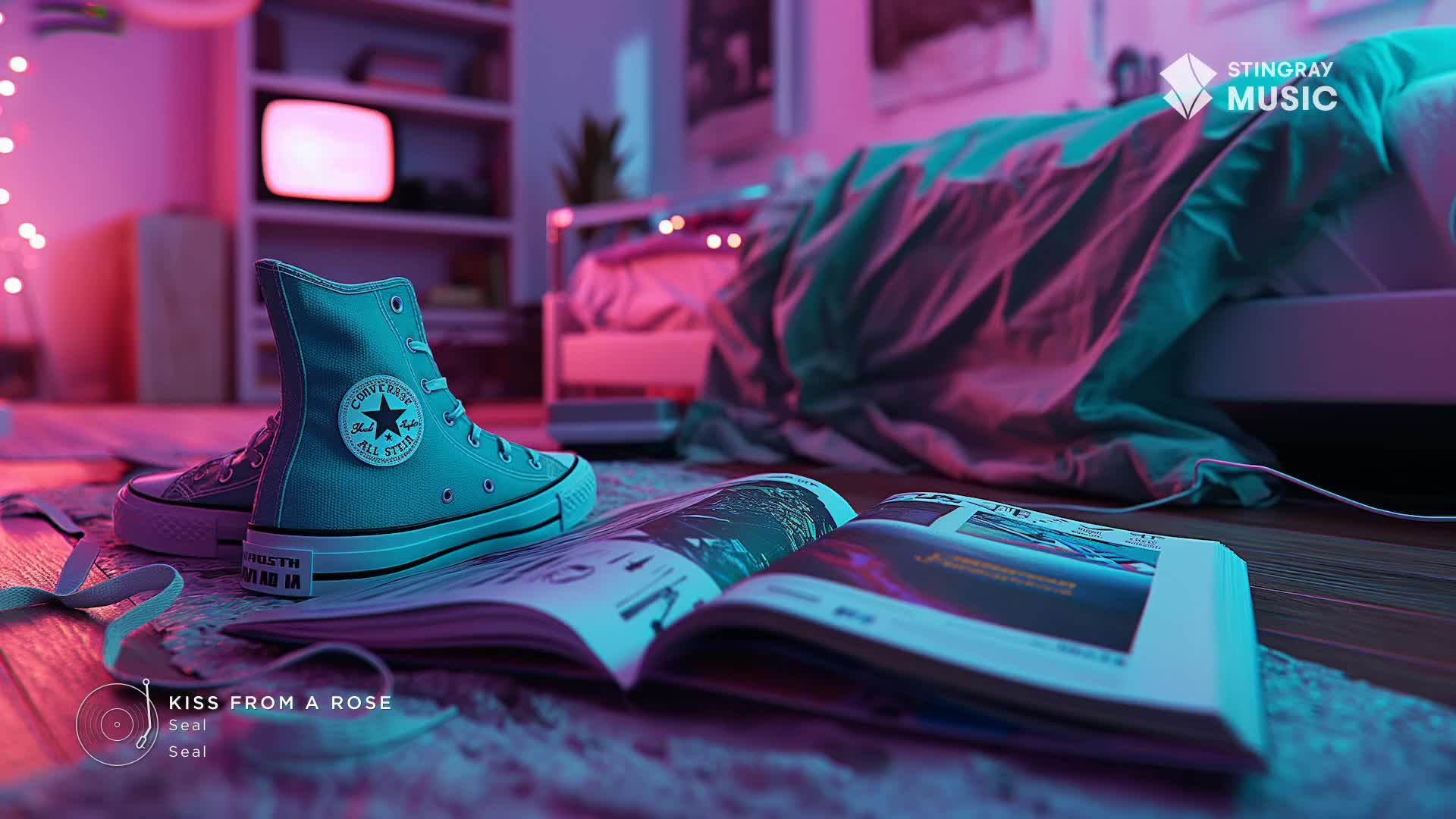 A pair of light blue Converse high-tops rests on an open magazine. The room is bathed in the neon glow of pink and teal lights, hinting at a Stingray Holiday Hits playlist.