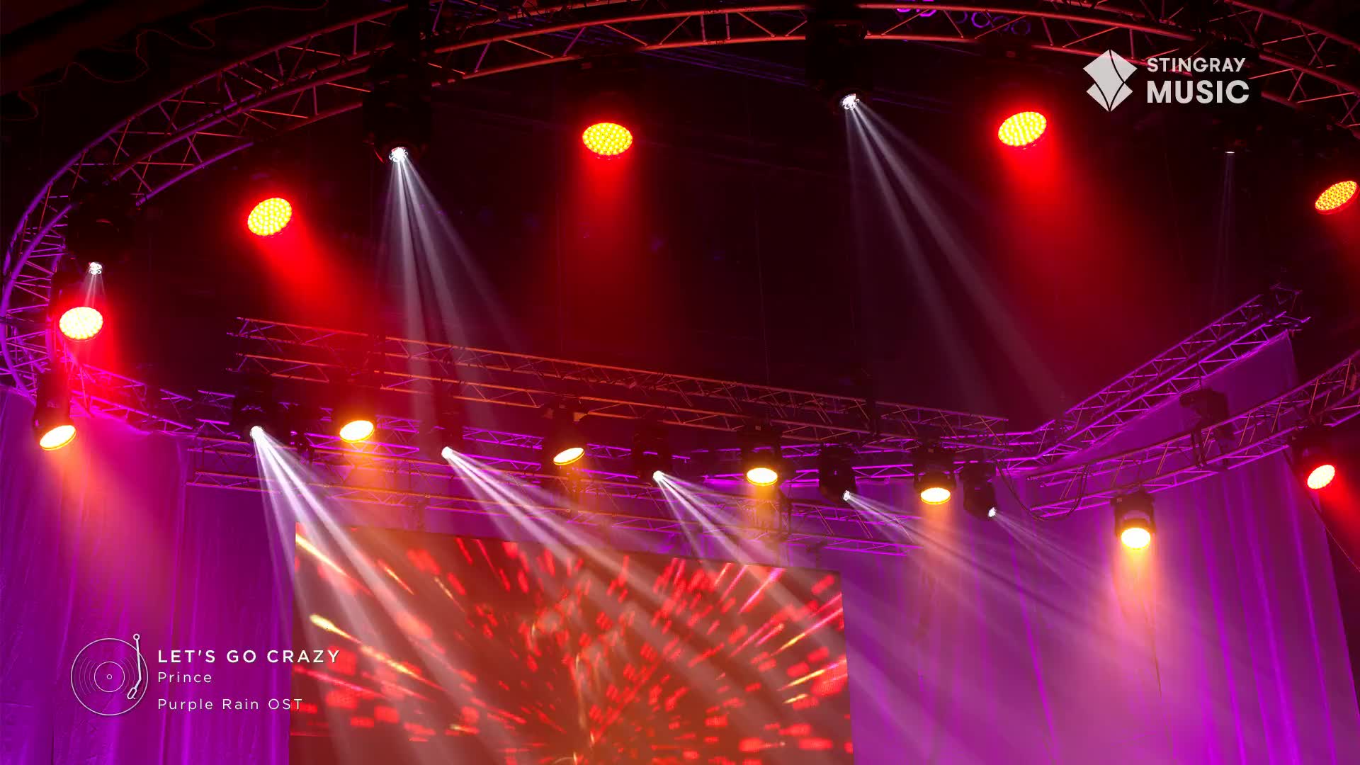 Bright red and white spotlights cut through the purple haze on stage. The Stingray Music logo is visible in the upper right corner, hinting at a Canadian broadcast.