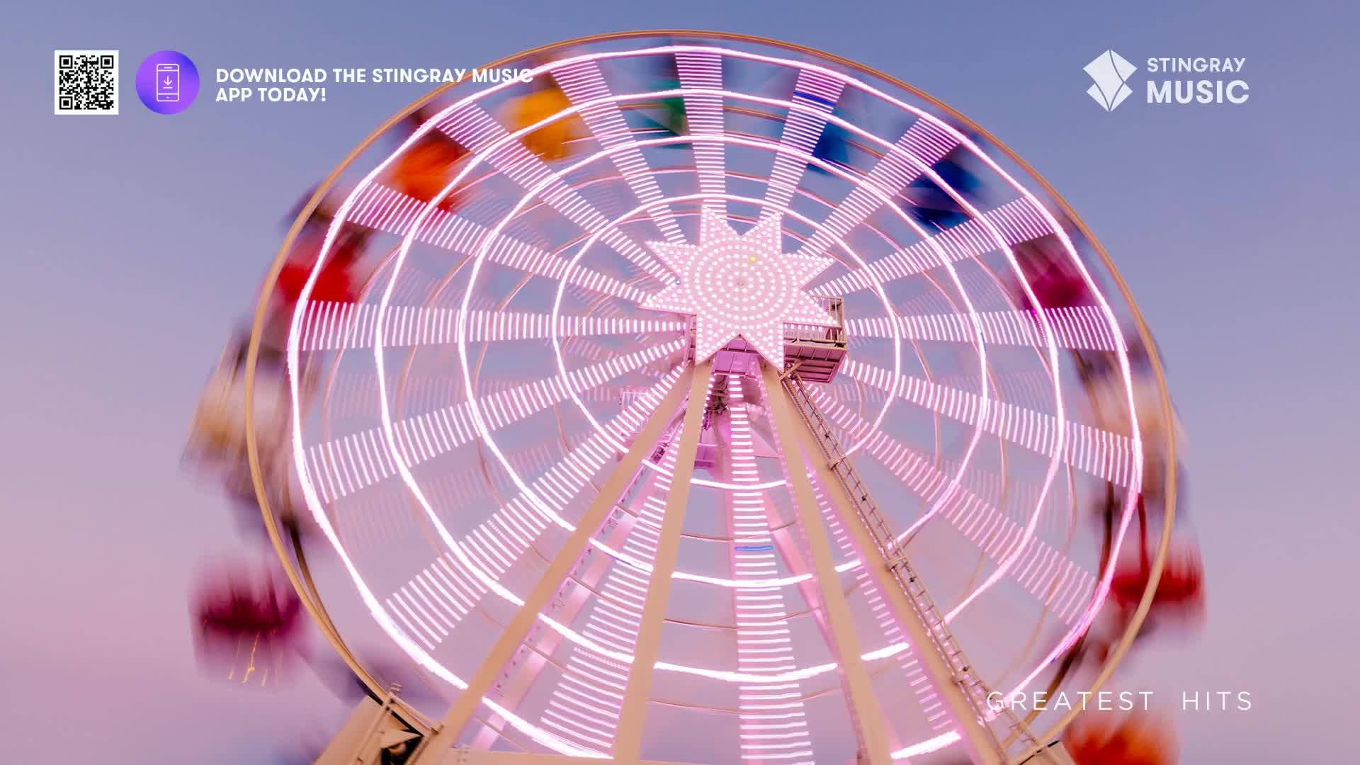 The Ferris wheel spins with its lights blurring into streaks of pink and white against the twilight sky.  This feels like a classic Canadian summer night, the kind that plays Stingray Holiday Hits.