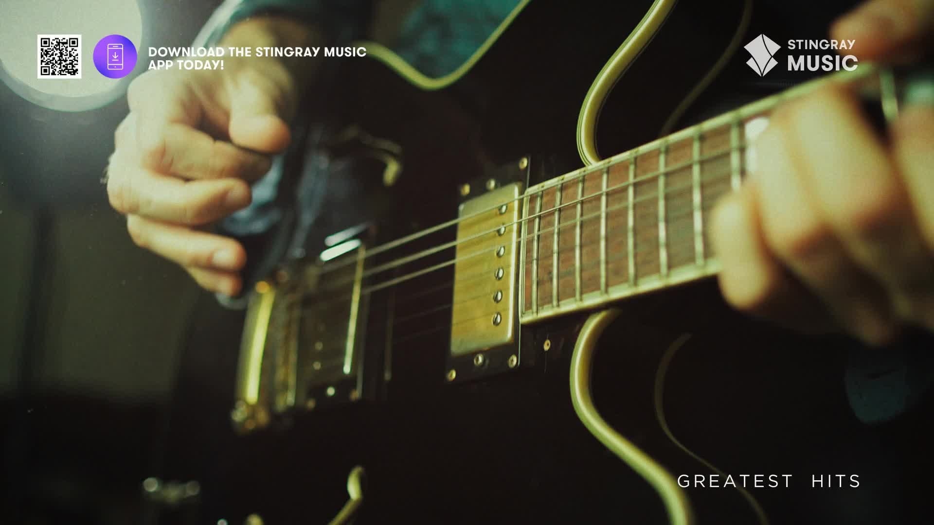 Fingers press down on the fretboard of a dark electric guitar. The strings hum with the promise of a Stingray Holiday Hits classic.